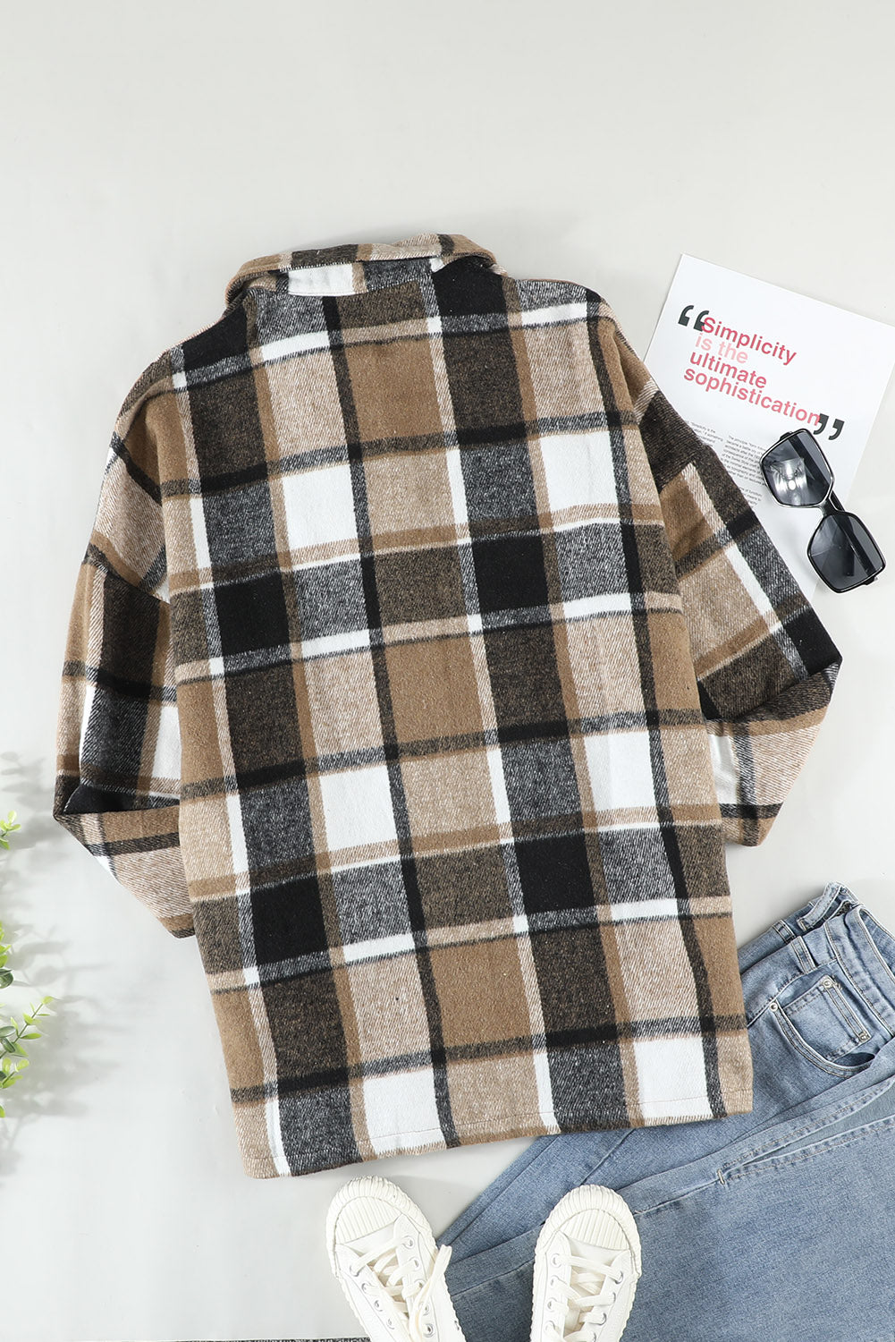 A stylish plaid print buttoned shirt jacket in warm tones, showcasing its soft fabric and button closure design.