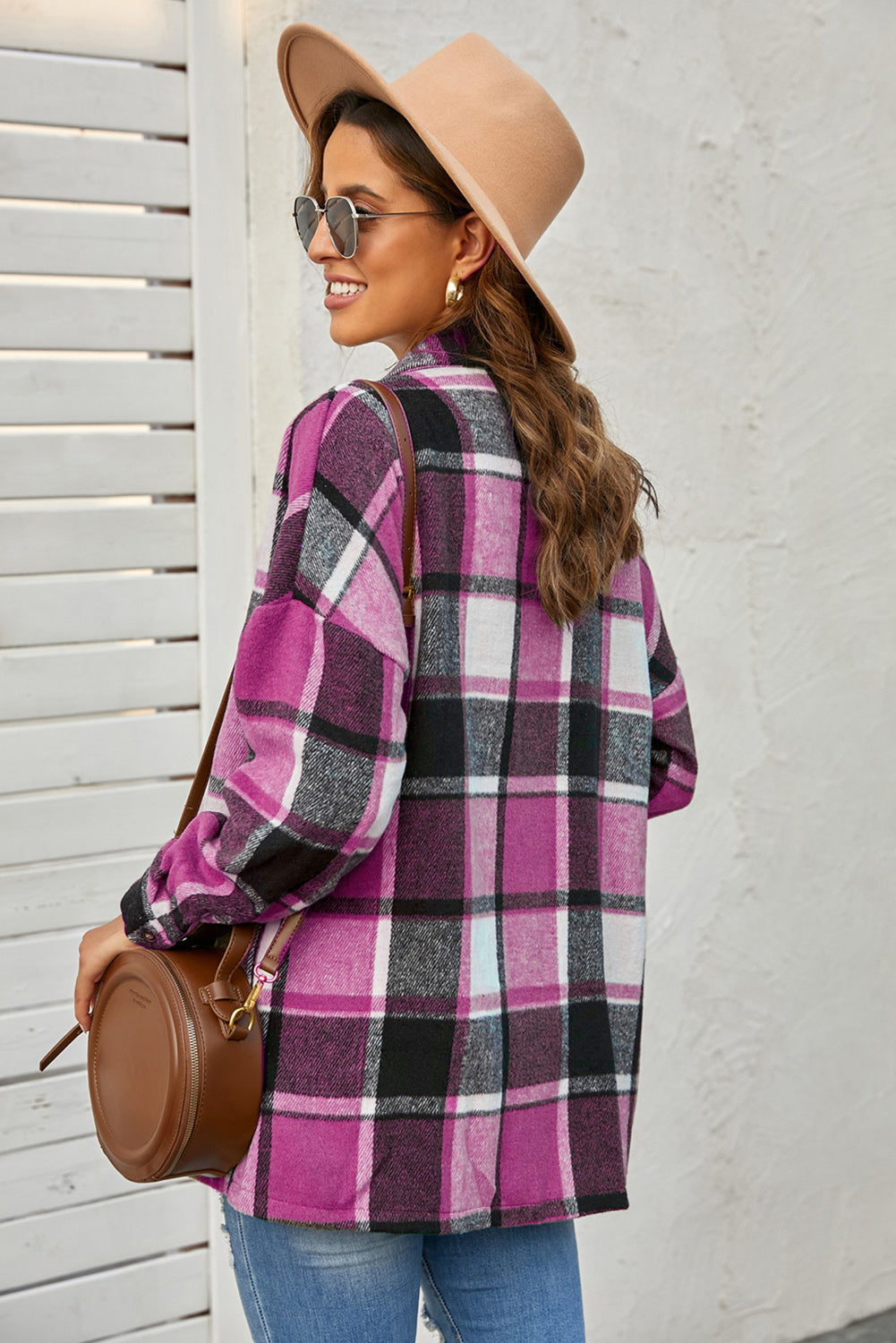 A stylish plaid print buttoned shirt jacket in warm tones, showcasing its soft fabric and button closure design.