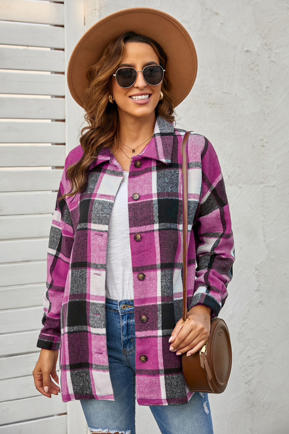 A stylish plaid print buttoned shirt jacket in warm tones, showcasing its soft fabric and button closure design.