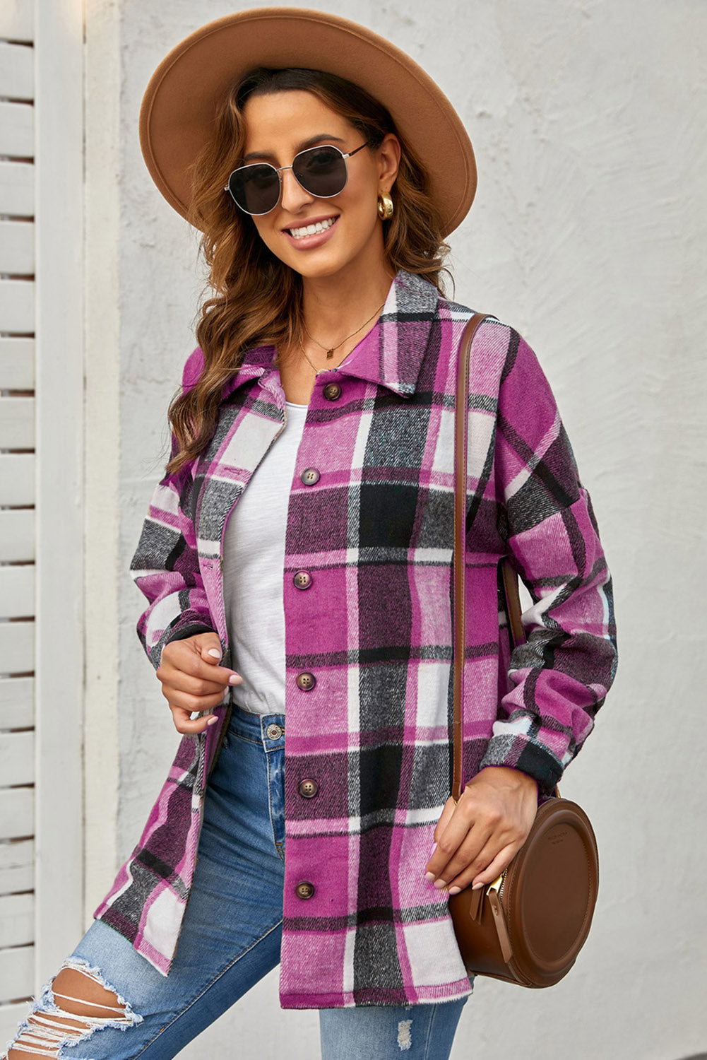 A stylish plaid print buttoned shirt jacket in warm tones, showcasing its soft fabric and button closure design.