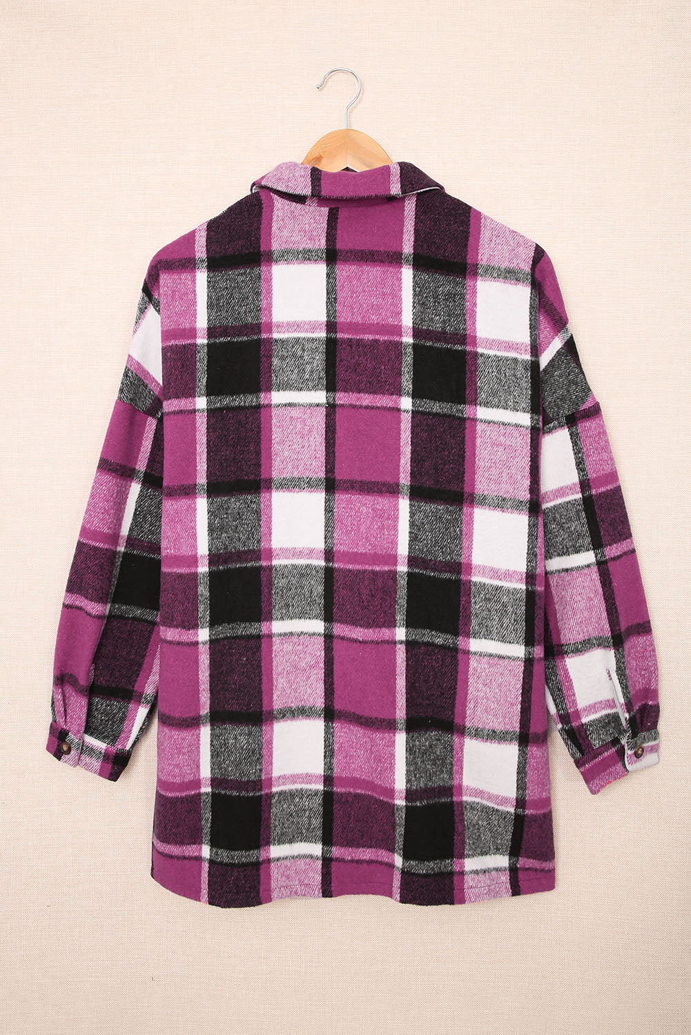 A stylish plaid print buttoned shirt jacket in warm tones, showcasing its soft fabric and button closure design.