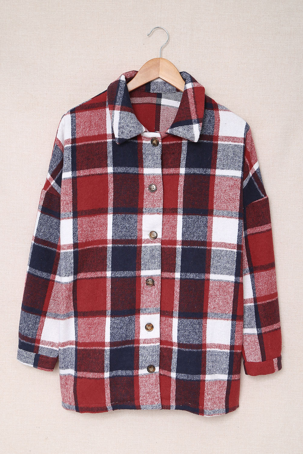 A stylish plaid print buttoned shirt jacket in warm tones, showcasing its soft fabric and button closure design.