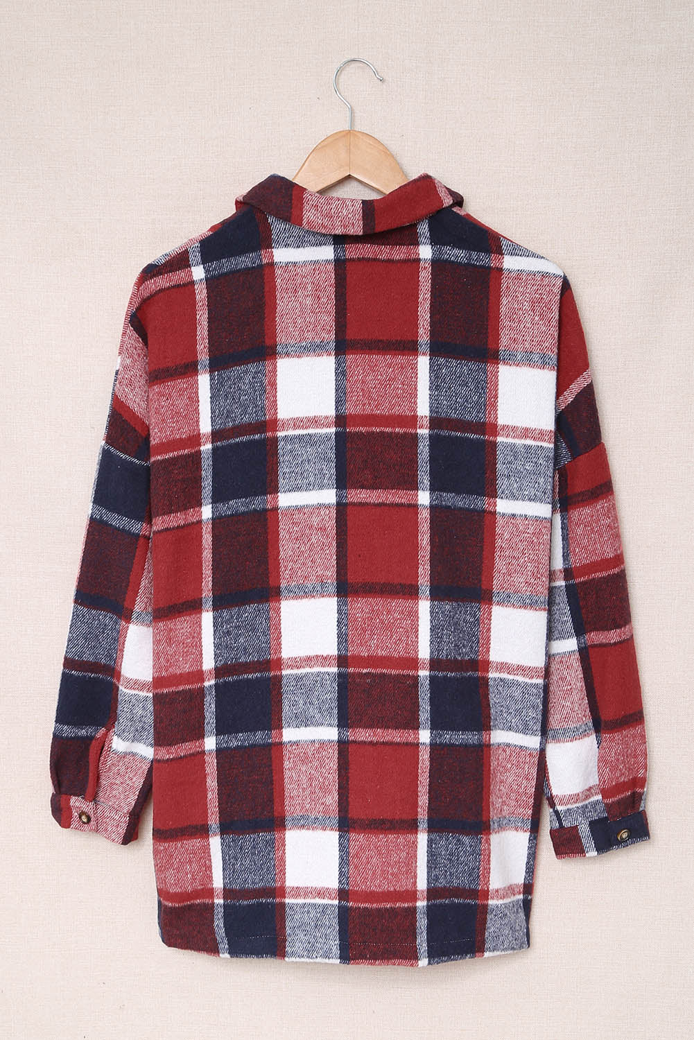 A stylish plaid print buttoned shirt jacket in warm tones, showcasing its soft fabric and button closure design.