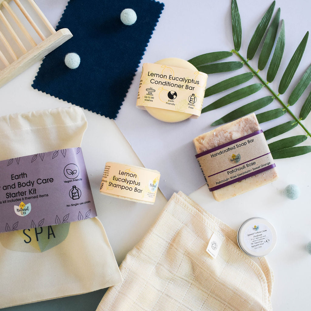 Plastic Free Hair and Body Wash Starter Kit featuring soap, shampoo, conditioner bars, bamboo washcloth, and recycled travel bag.