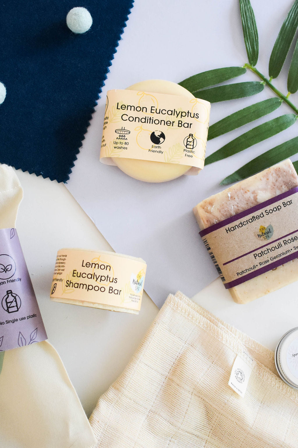 Plastic Free Hair and Body Wash Starter Kit featuring soap, shampoo, conditioner bars, bamboo washcloth, and recycled travel bag.