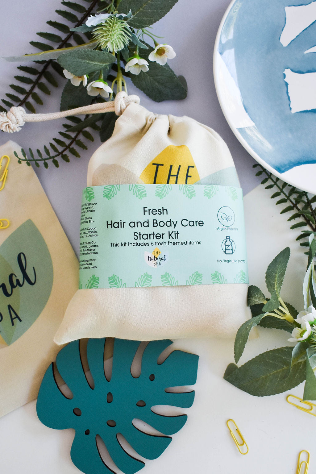 Plastic Free Hair and Body Wash Starter Kit featuring soap, shampoo, conditioner bars, bamboo washcloth, and recycled travel bag.