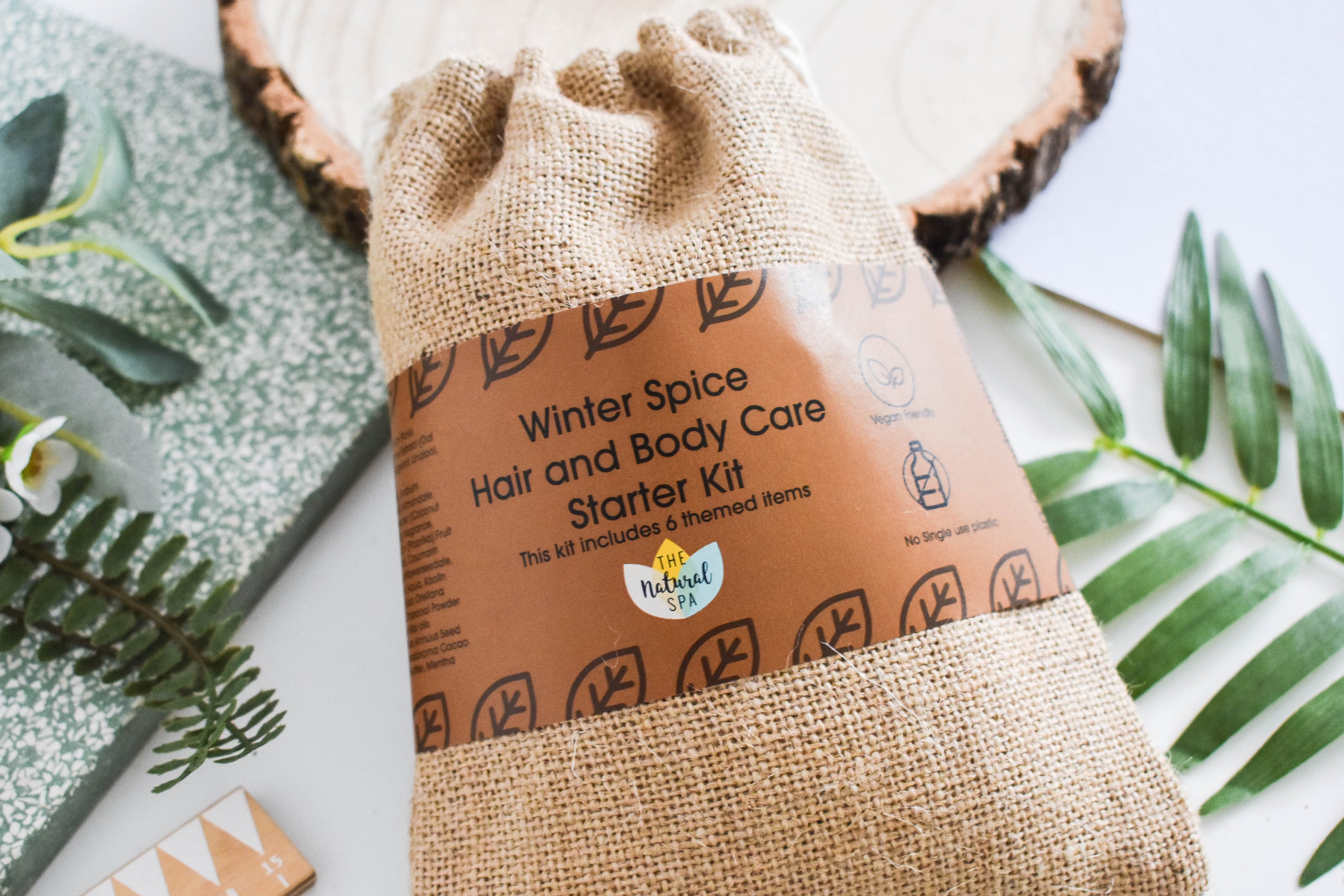 Plastic Free Hair and Body Wash Starter Kit featuring soap, shampoo, conditioner bars, bamboo washcloth, and recycled travel bag.