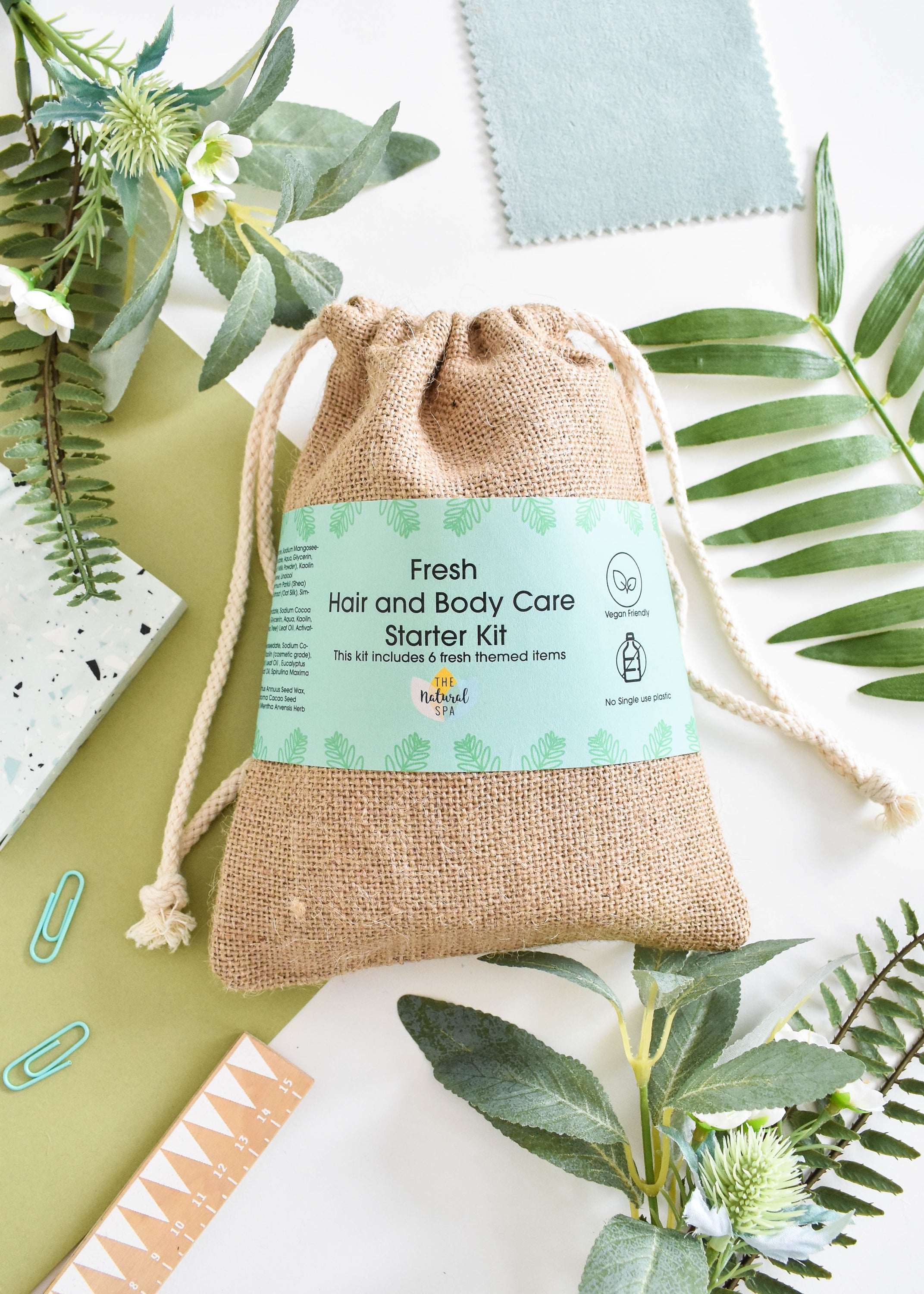 Plastic Free Hair and Body Wash Starter Kit featuring soap, shampoo, conditioner bars, bamboo washcloth, and recycled travel bag.