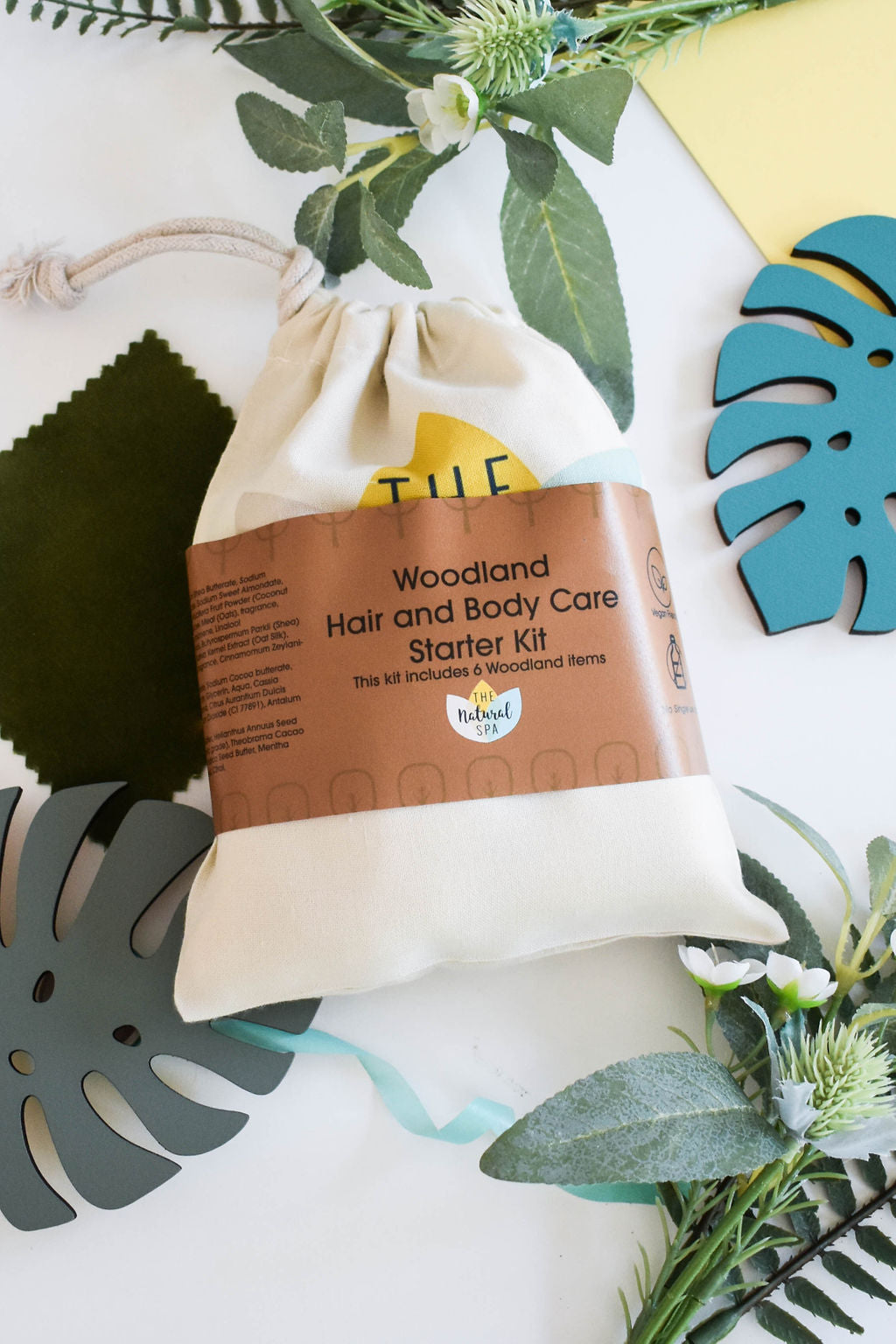 Plastic Free Hair and Body Wash Starter Kit featuring soap, shampoo, conditioner bars, bamboo washcloth, and recycled travel bag.