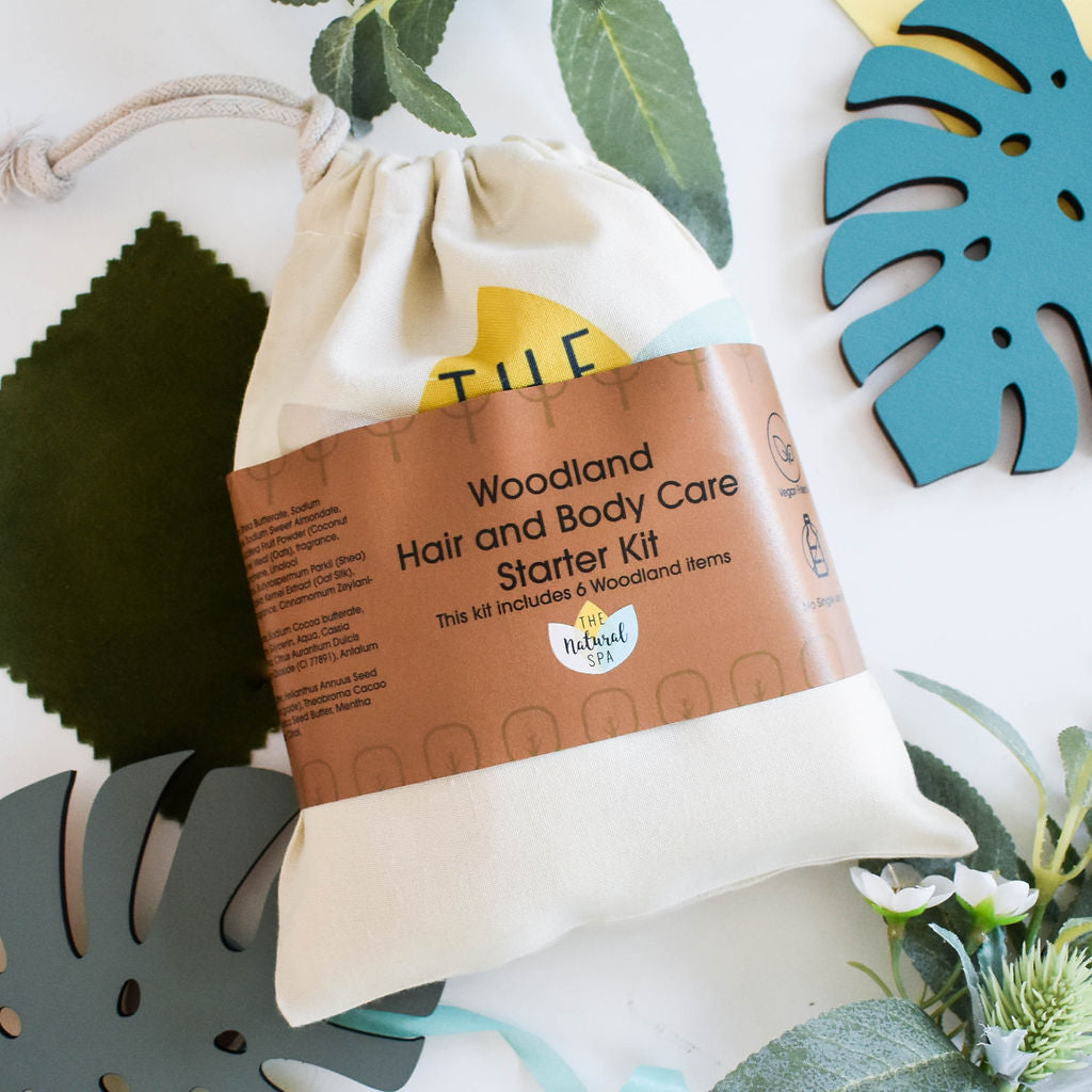 Plastic Free Hair and Body Wash Starter Kit featuring soap, shampoo, conditioner bars, bamboo washcloth, and recycled travel bag.