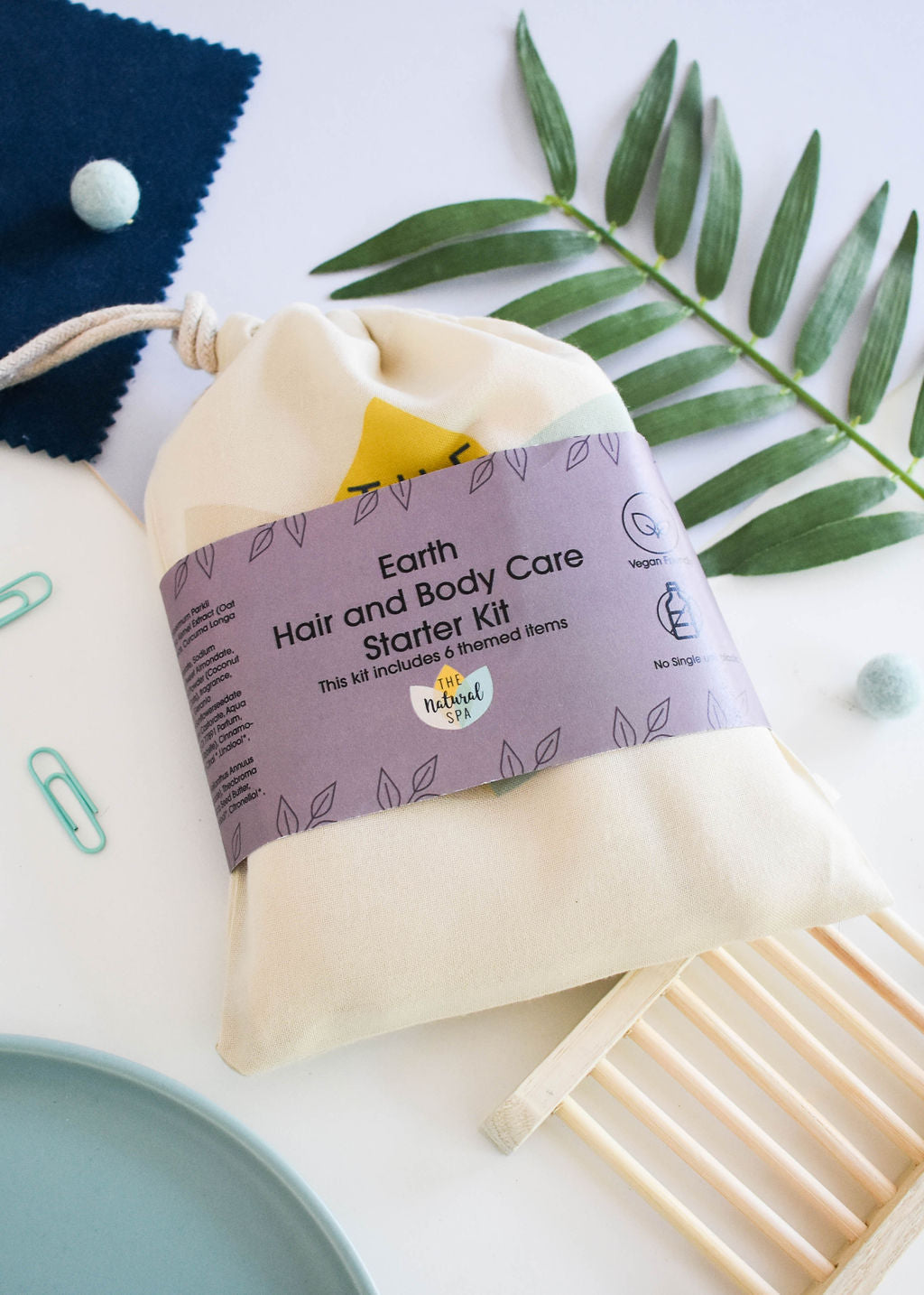 Plastic Free Hair and Body Wash Starter Kit featuring soap, shampoo, conditioner bars, bamboo washcloth, and recycled travel bag.