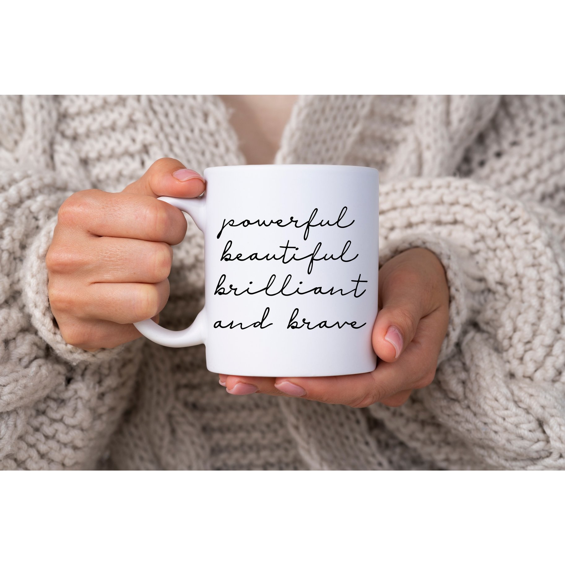 A glossy white ceramic mug with vibrant inkjet printed artwork, showcasing the phrase 'Powerful, Beautiful, Brilliant Brave' in an elegant design.