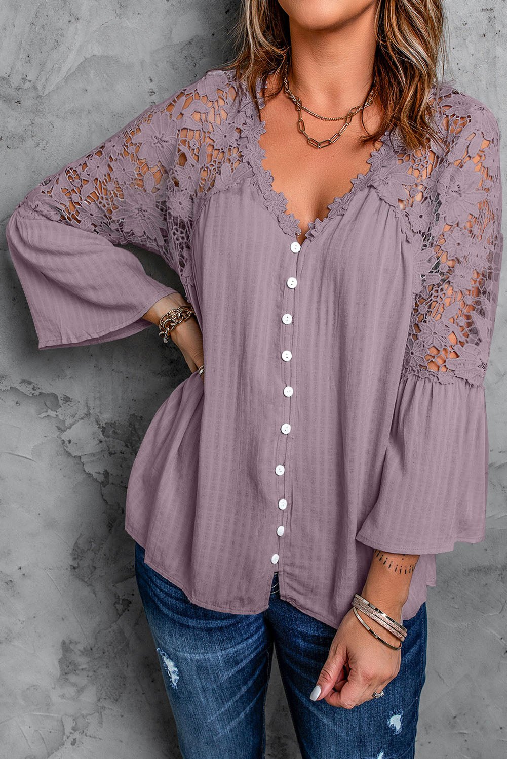 A stylish Purple Crochet Lace Button Top featuring intricate lace detailing, a v-neckline, and ¾ bell sleeves, perfect for various occasions.