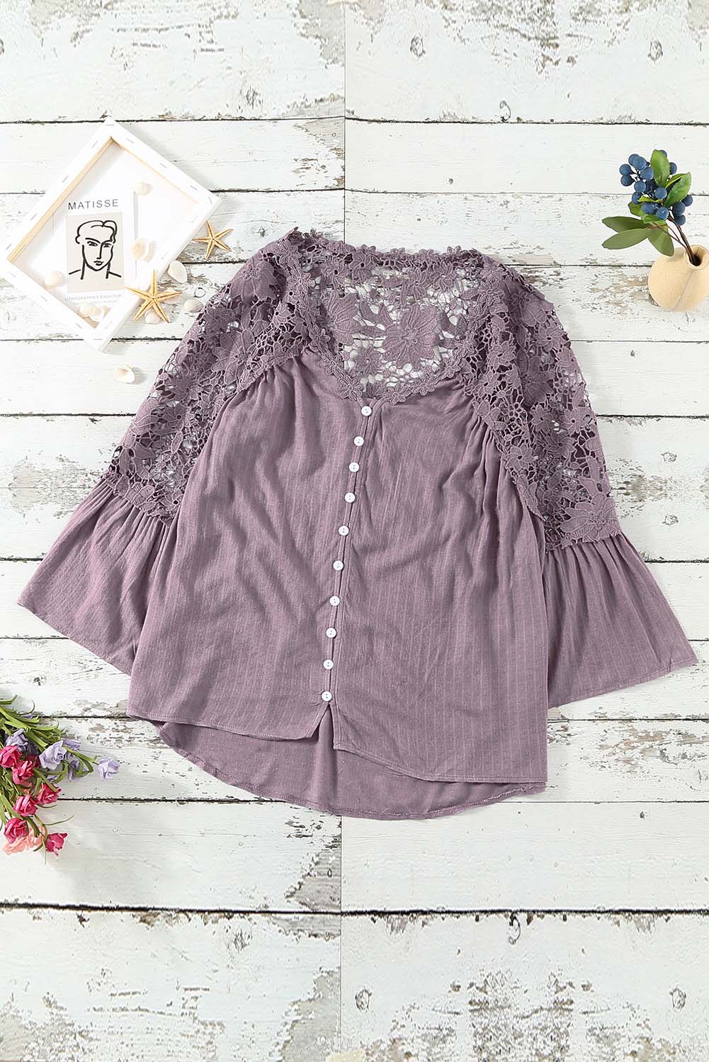 A stylish Purple Crochet Lace Button Top featuring intricate lace detailing, a v-neckline, and ¾ bell sleeves, perfect for various occasions.