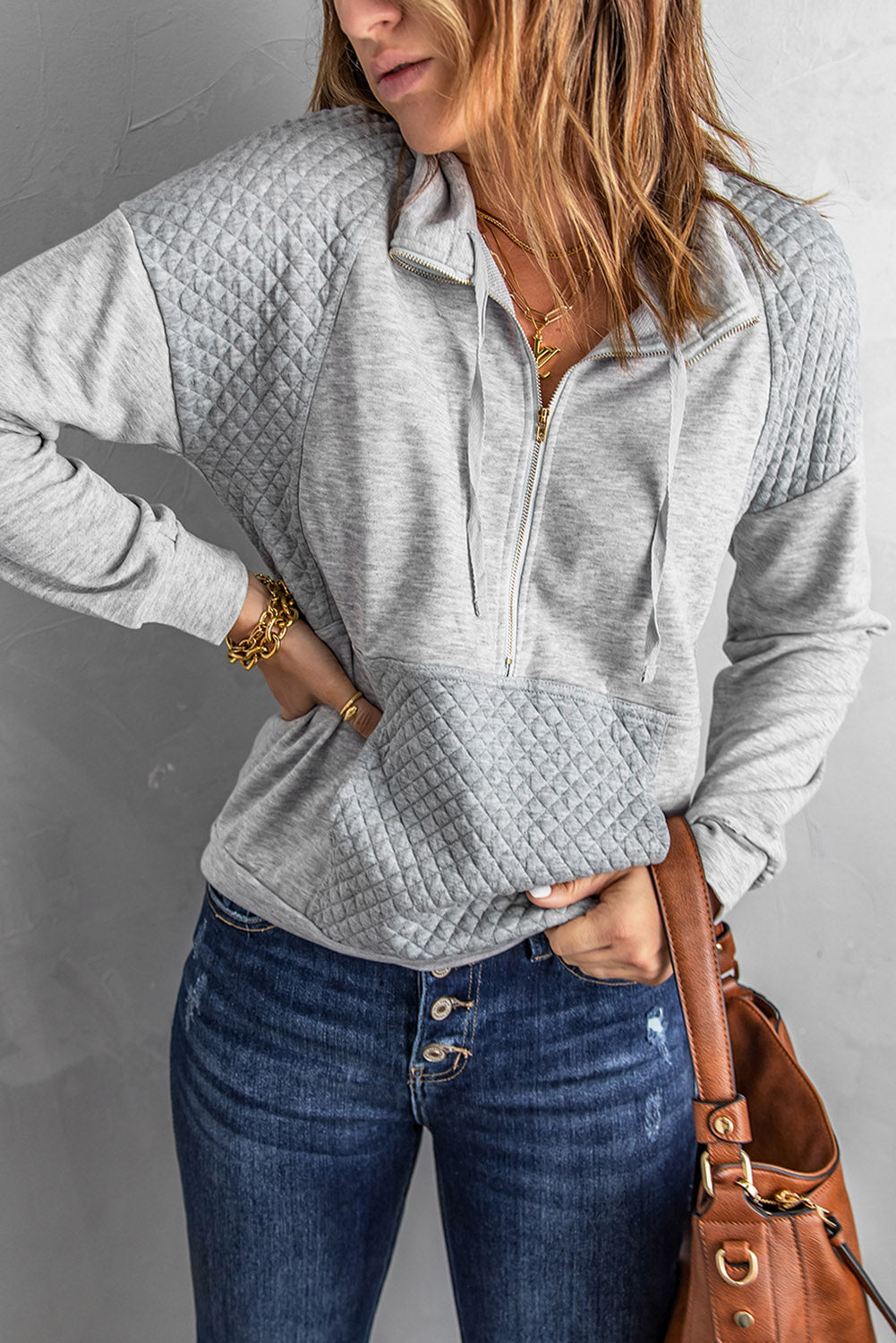 A stylish quilted patch half zipper sweatshirt in solid color, showcasing its unique texture and chic design.