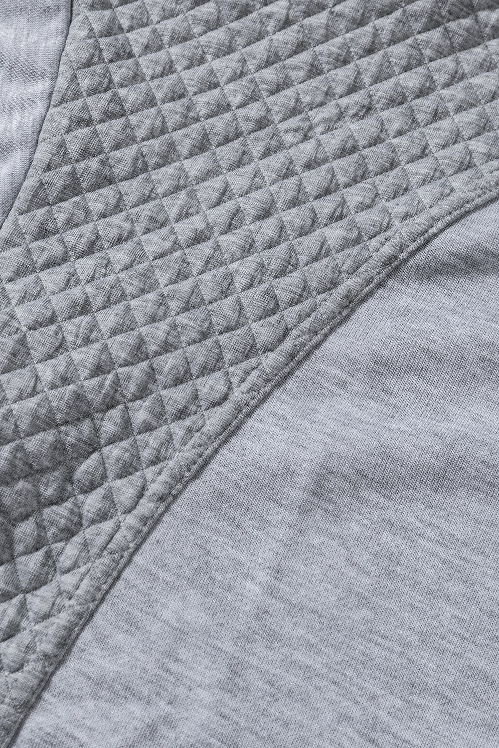 A stylish quilted patch half zipper sweatshirt in solid color, showcasing its unique texture and chic design.