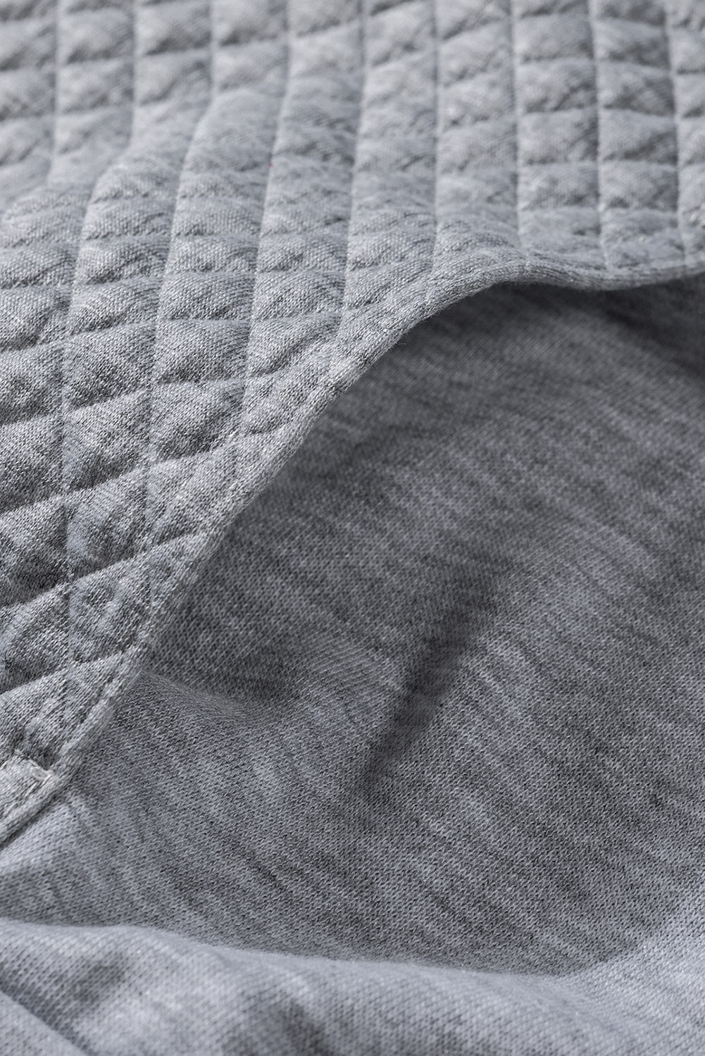 A stylish quilted patch half zipper sweatshirt in solid color, showcasing its unique texture and chic design.