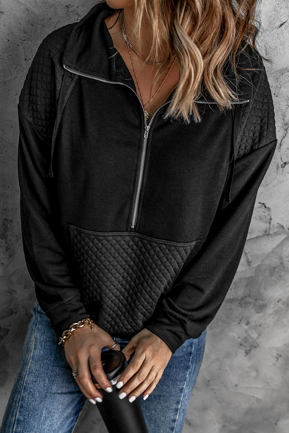 A stylish quilted patch half zipper sweatshirt in solid color, showcasing its unique texture and chic design.