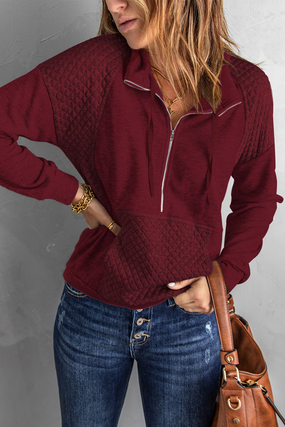 A stylish quilted patch half zipper sweatshirt in solid color, showcasing its unique texture and chic design.