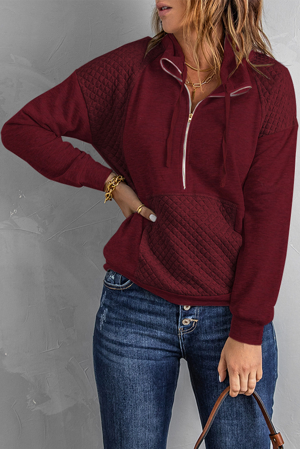 A stylish quilted patch half zipper sweatshirt in solid color, showcasing its unique texture and chic design.