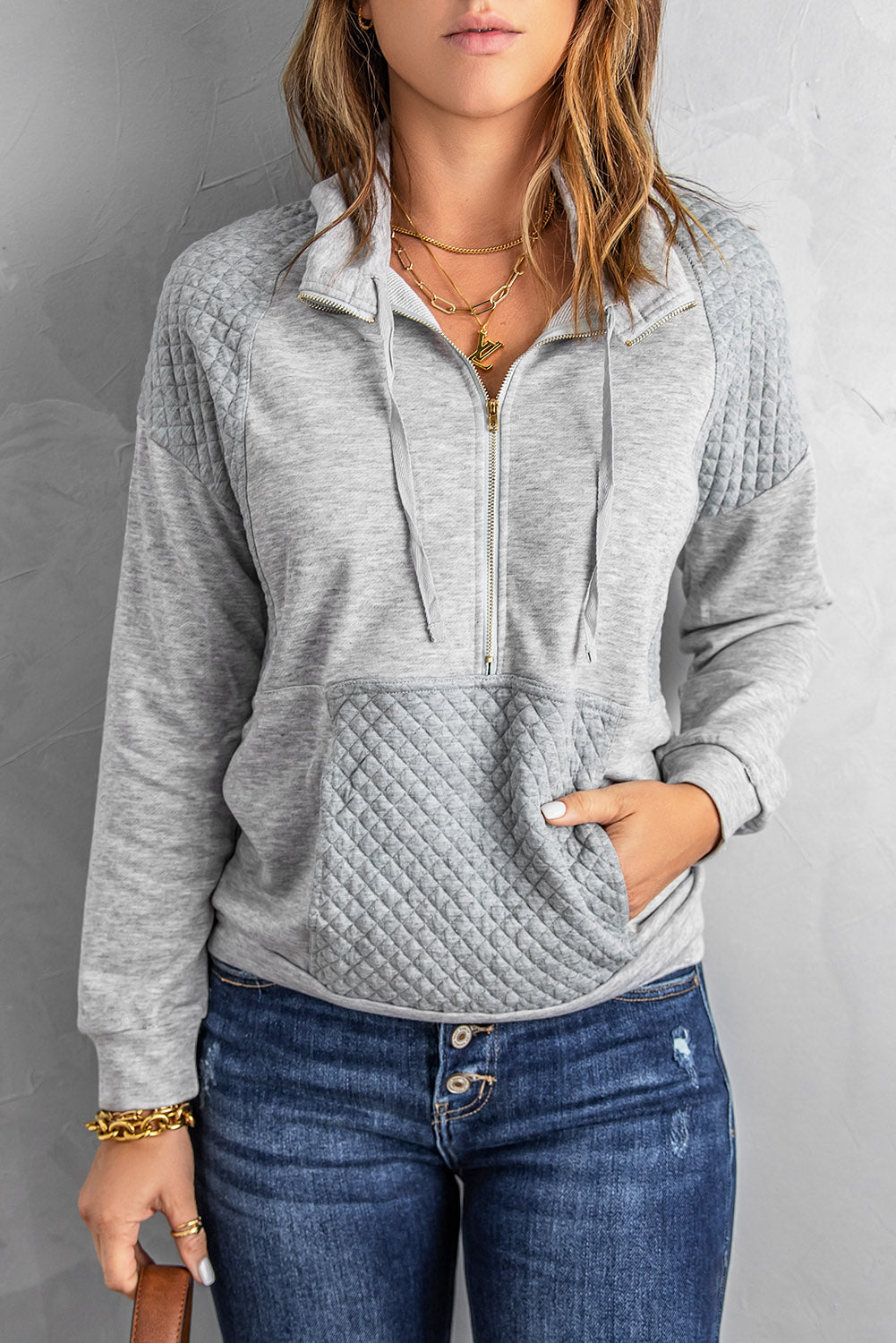 A stylish quilted patch half zipper sweatshirt in solid color, showcasing its unique texture and chic design.