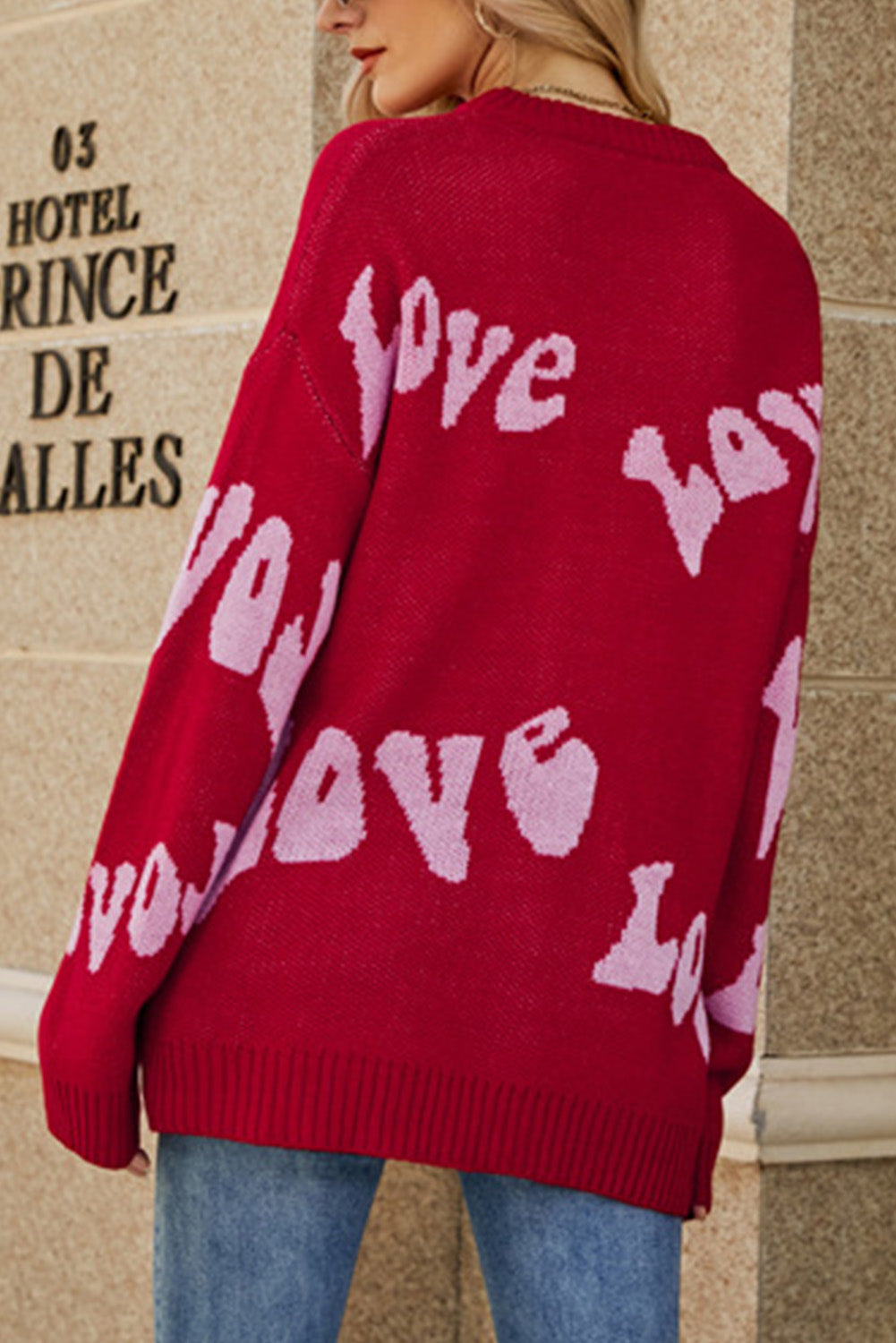 Racing Red Groovy LOVE Slouchy Sweater featuring a relaxed fit and eye-catching LOVE graphic, perfect for casual wear.