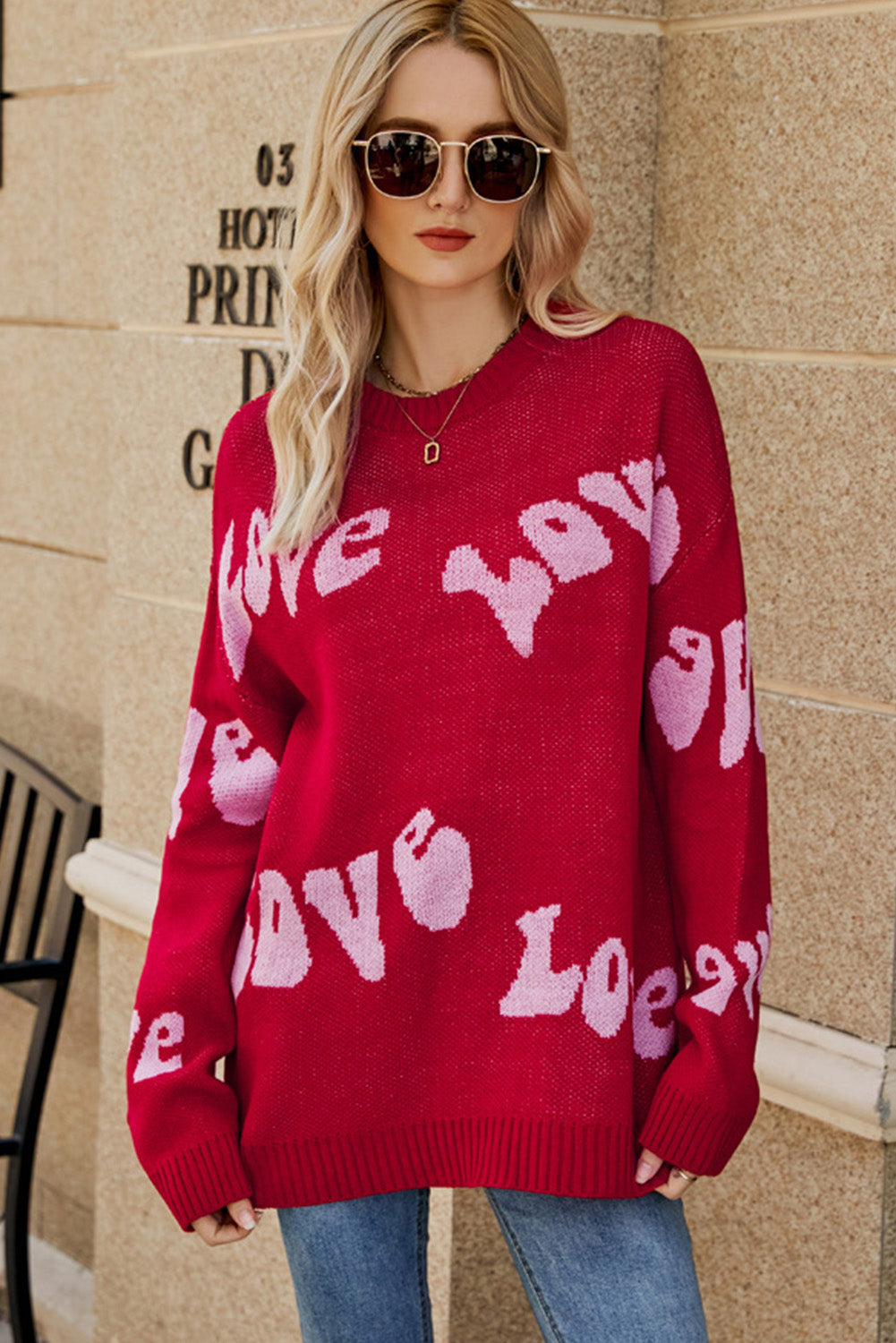 Racing Red Groovy LOVE Slouchy Sweater featuring a relaxed fit and eye-catching LOVE graphic, perfect for casual wear.