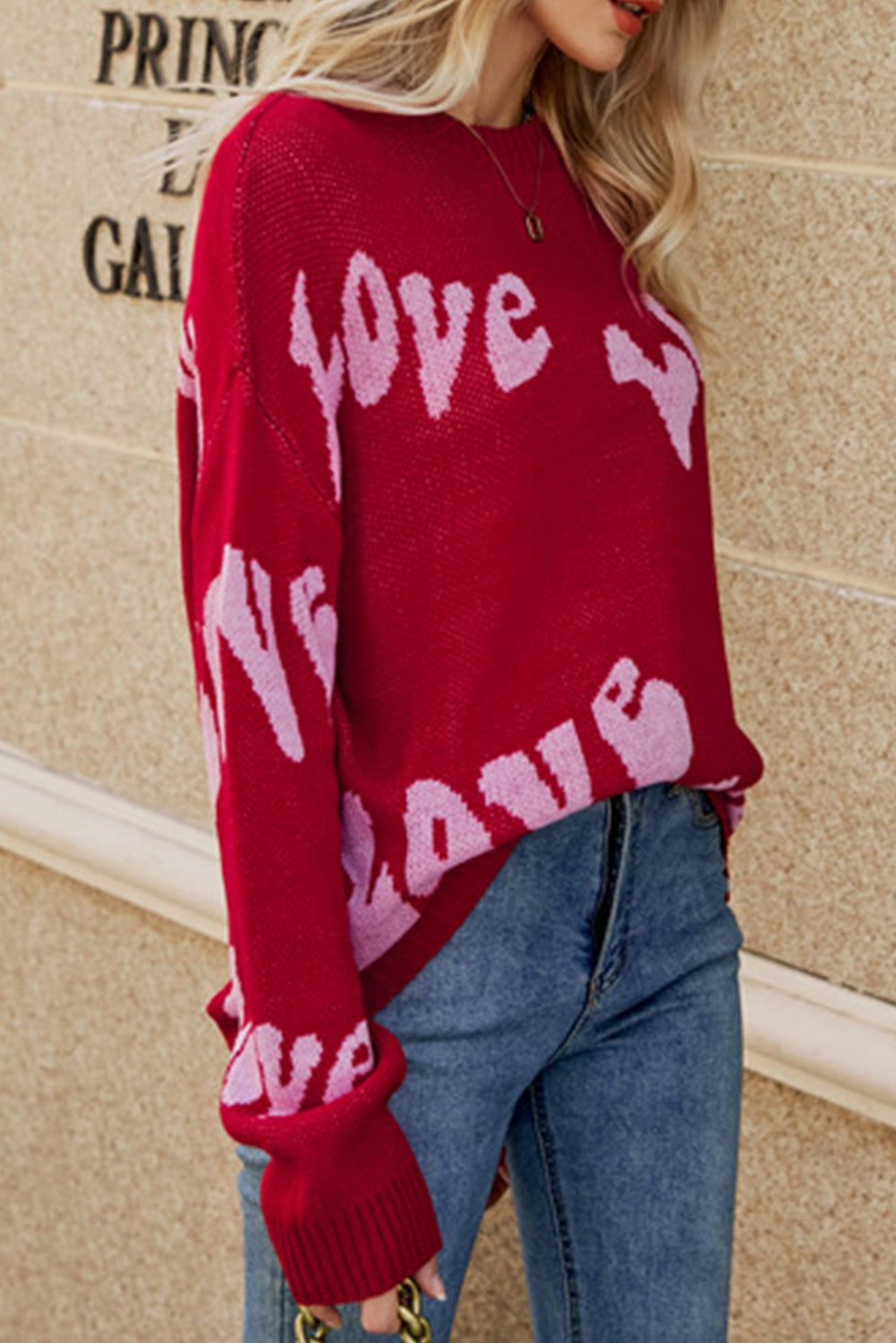 Racing Red Groovy LOVE Slouchy Sweater featuring a relaxed fit and eye-catching LOVE graphic, perfect for casual wear.