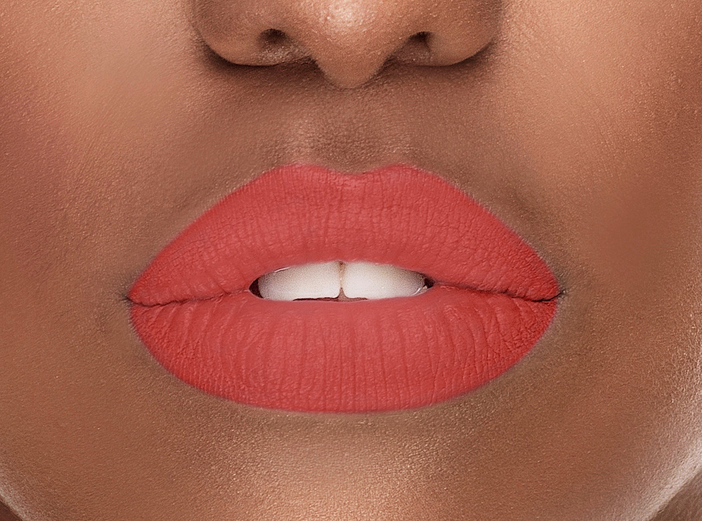 Radiance Silk-Matte Lipstick in Coral Pink shade, showcasing its sleek design and vibrant color, perfect for a luxurious lip experience.