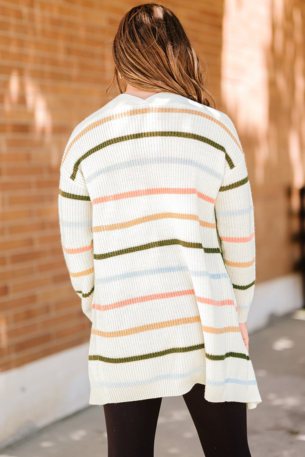 A cozy Rainbow Striped Cardigan featuring vibrant colors and a soft texture, perfect for layering in any season.