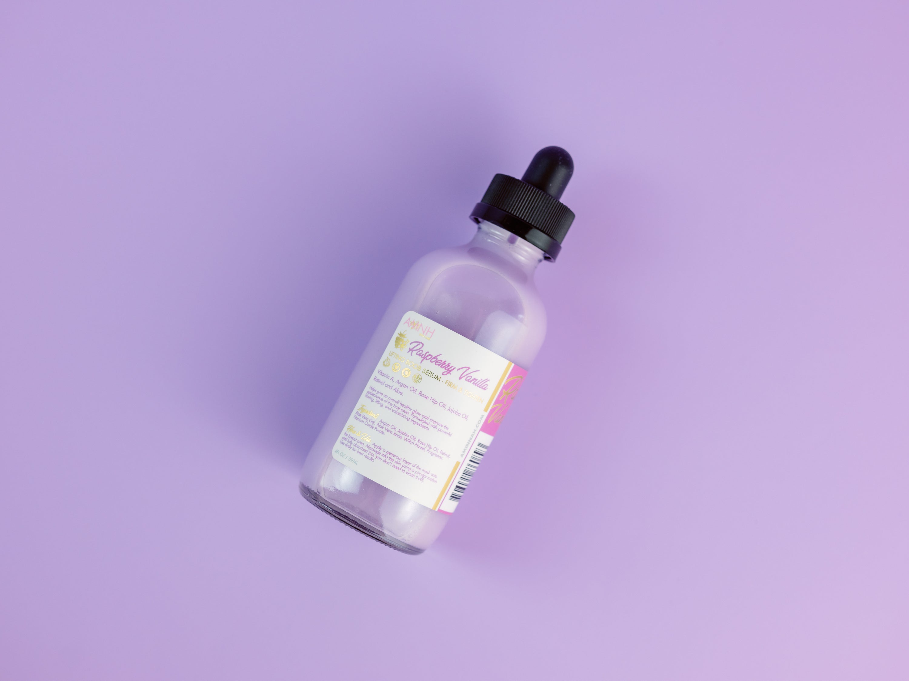 Dropper bottle on violet background