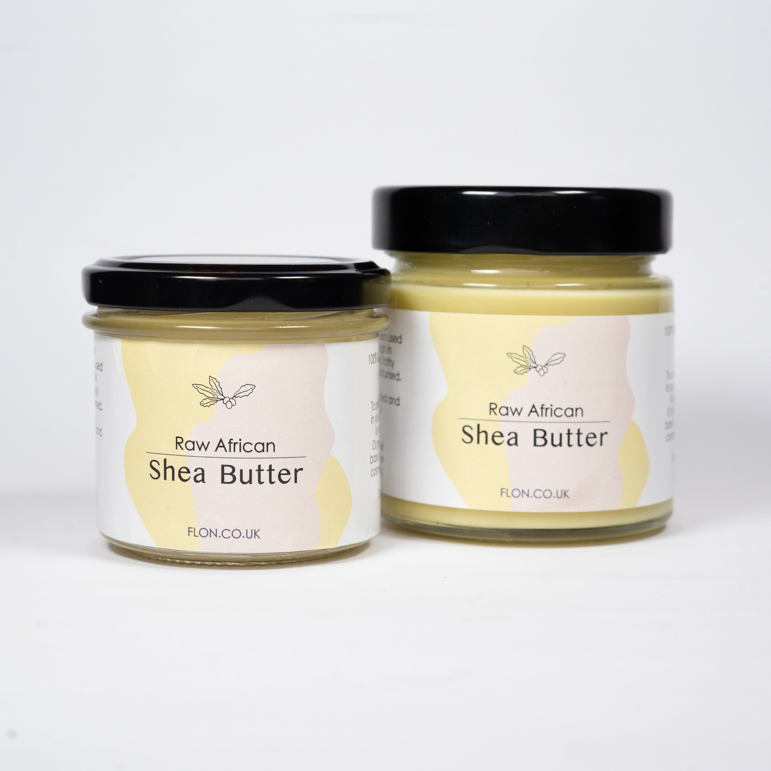 A jar of Raw Unrefined African Shea Butter, showcasing its creamy texture and natural color, surrounded by Shea nuts and leaves.