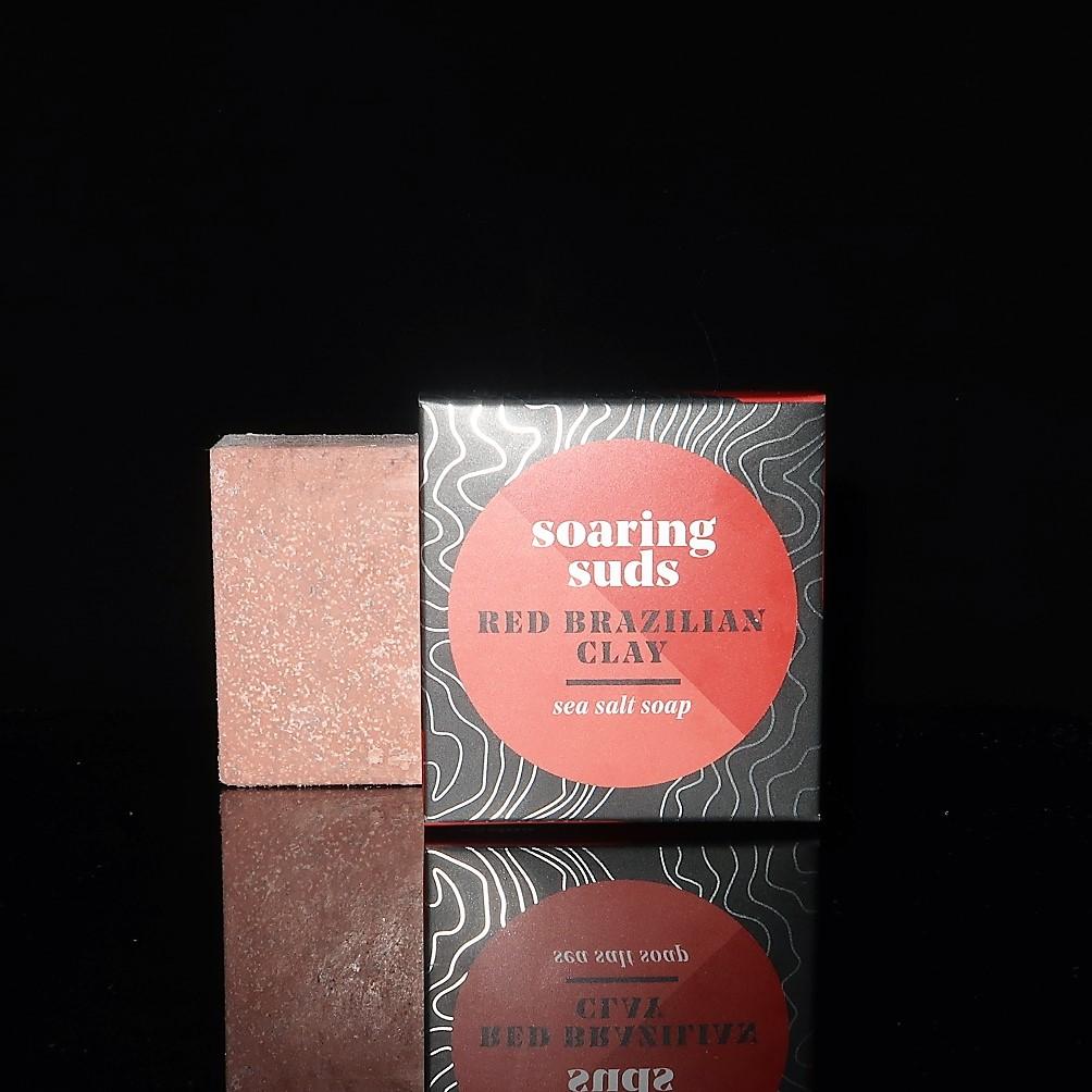 Red Brazilian Clay Sea Salt Spa Bar with natural ingredients, showcasing its unique texture and vibrant color.