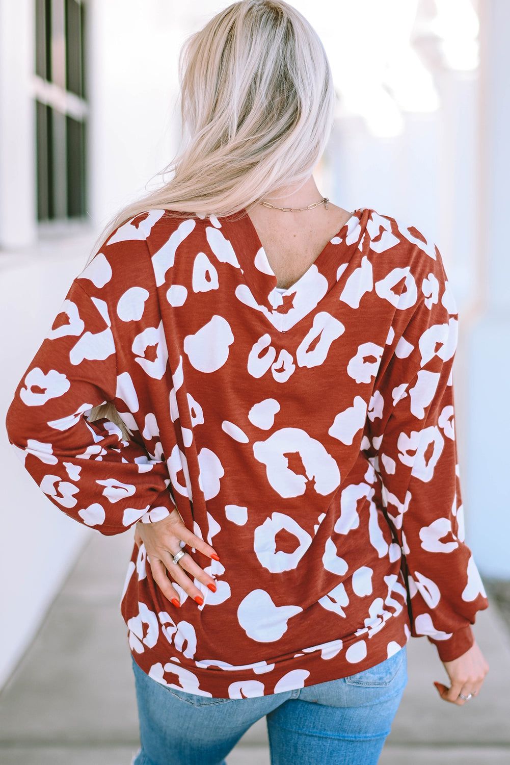 Red Clay Leopard Print Bishop Sleeve V-Neck Top featuring a relaxed fit and stylish puff sleeves, perfect for casual wear.