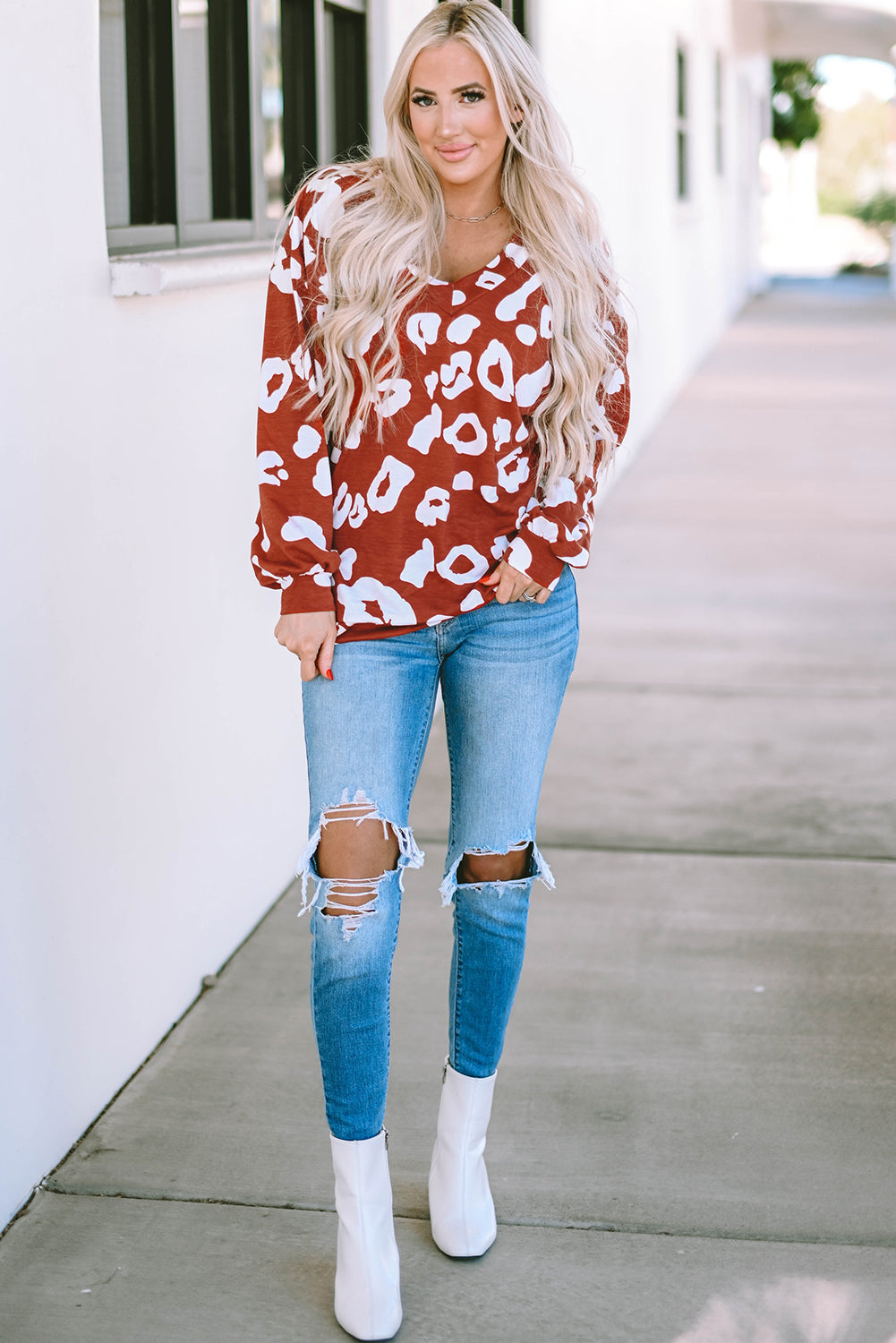 Red Clay Leopard Print Bishop Sleeve V-Neck Top featuring a relaxed fit and stylish puff sleeves, perfect for casual wear.