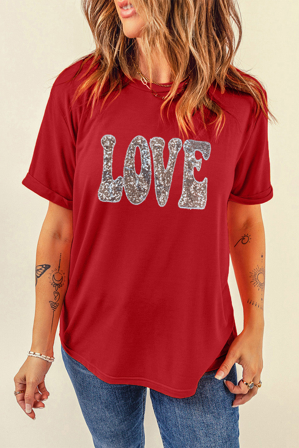 A vibrant red T-shirt featuring a sequined 'LOVE' design, perfect for Valentine's Day and summer wear.