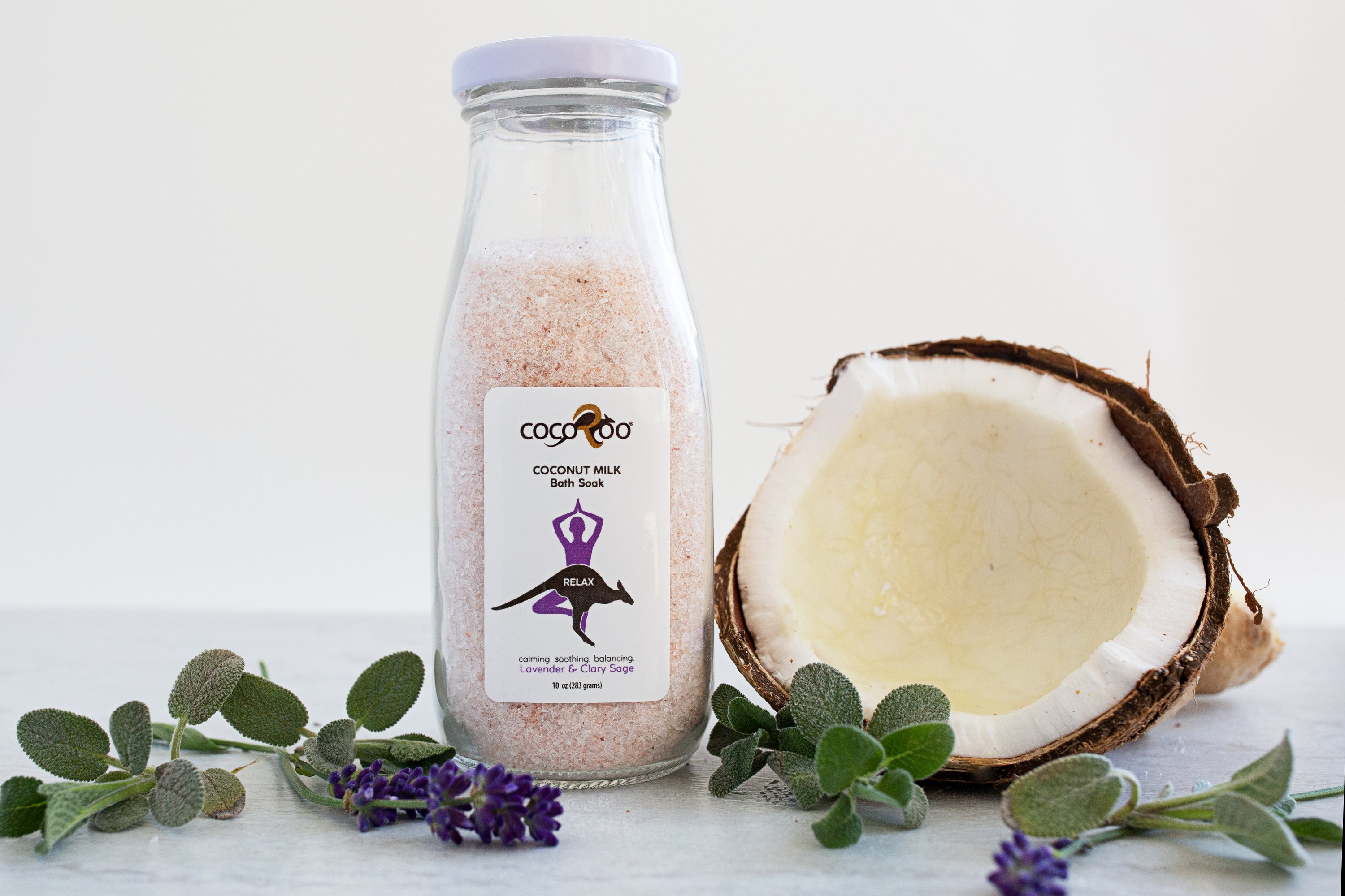 A serene bath setting featuring RELAX Coconut Milk Bath Soak with pink Himalayan salt and essential oils, promoting relaxation and skin nourishment.