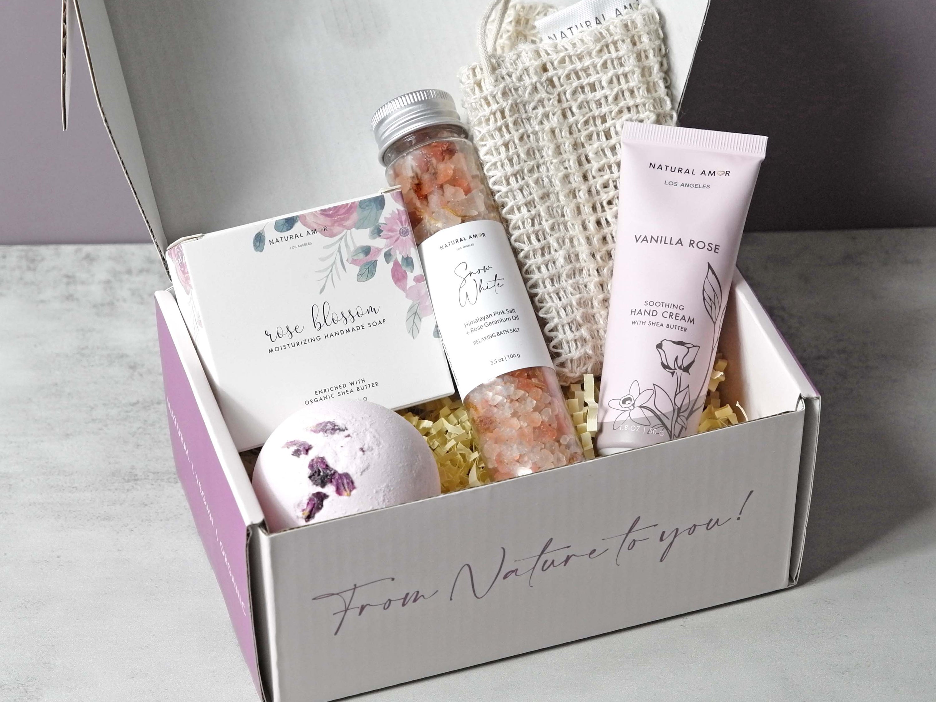 Relaxing Rose Gift Set featuring rose honey soap, bath salts, bath bomb, hand cream, and soap saver in a stylish gift box.