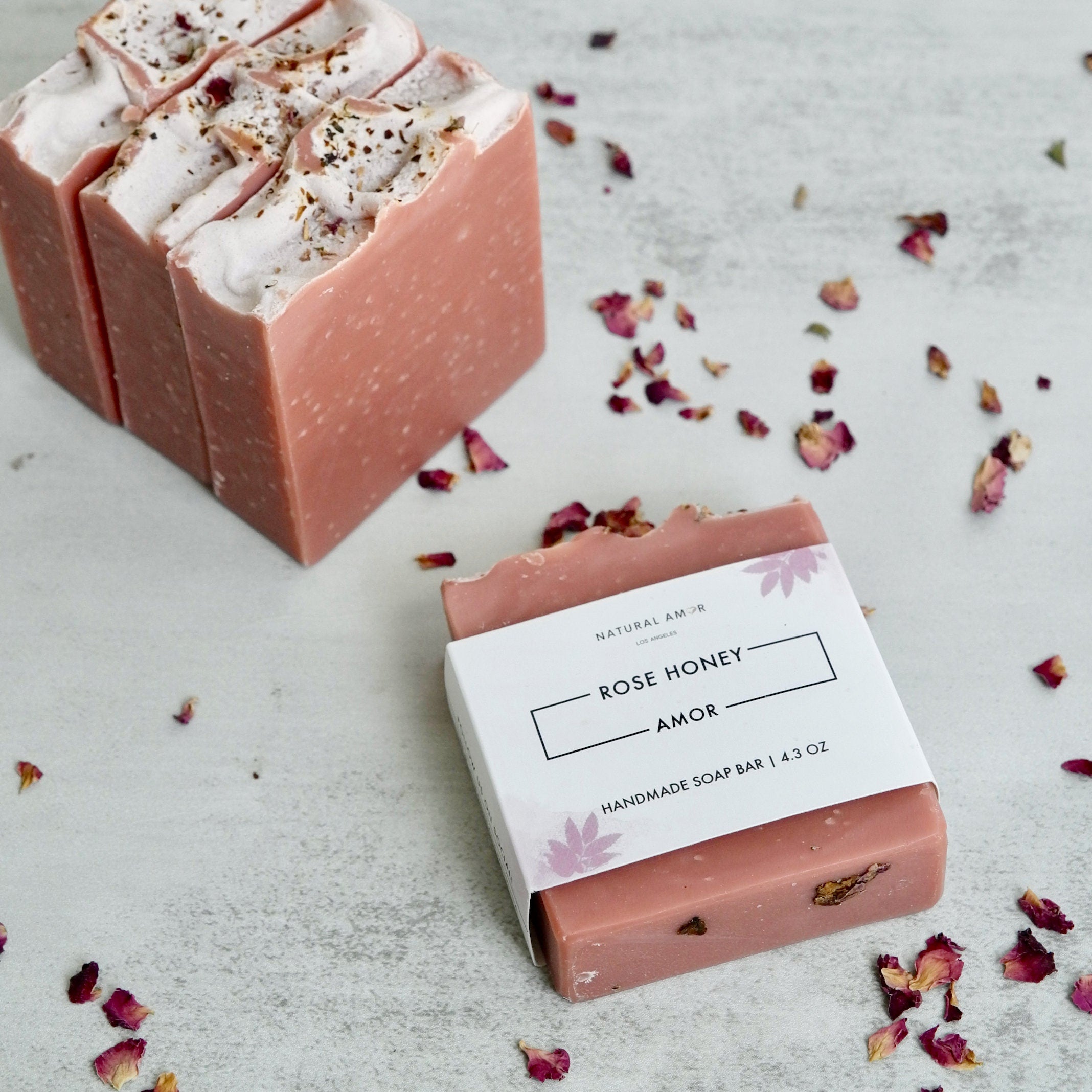 Relaxing Rose Gift Set featuring rose honey soap, bath salts, bath bomb, hand cream, and soap saver in a stylish gift box.