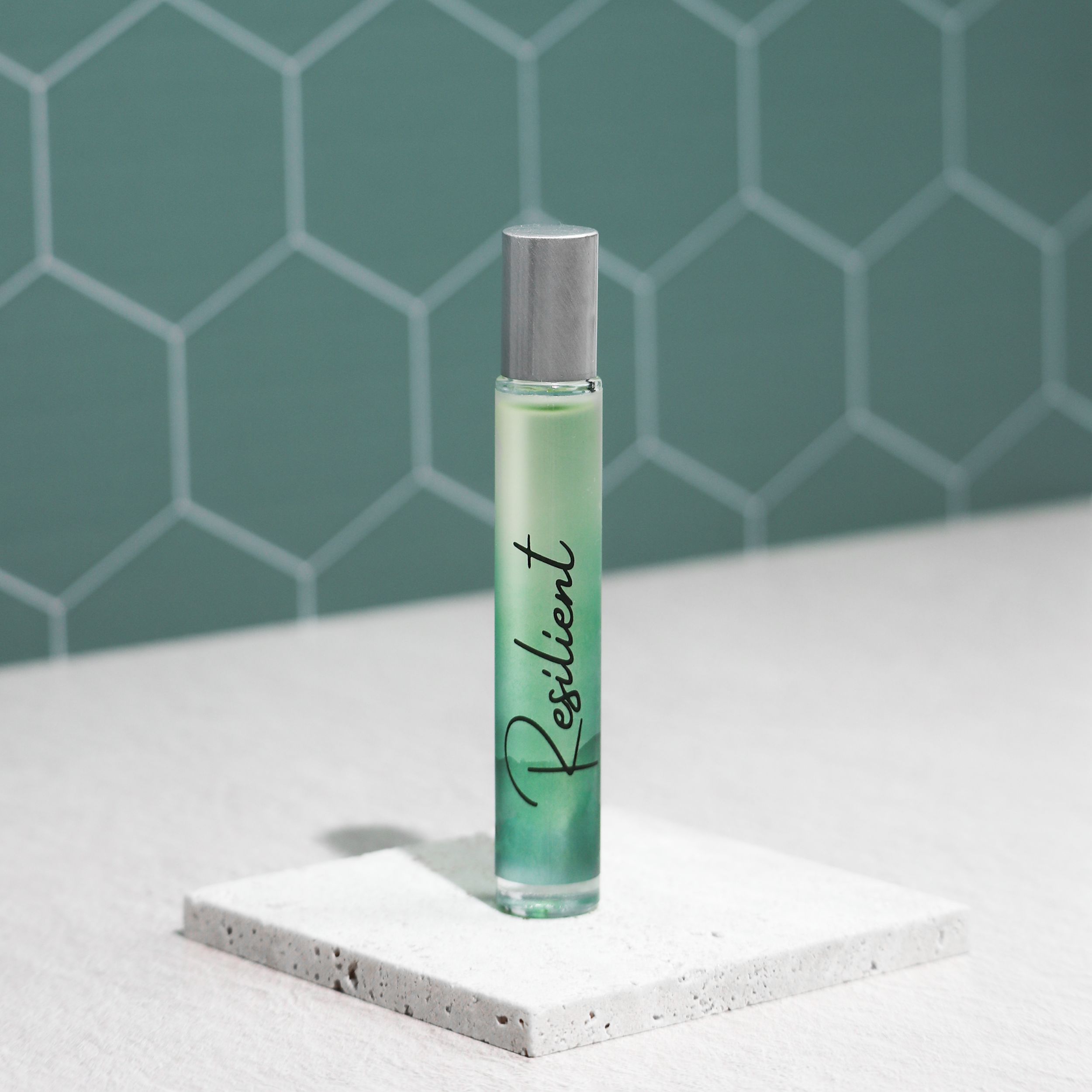 Resilient Rollerball Perfume in a stylish bottle, showcasing its floral and woody fragrance notes, perfect for empowering women.