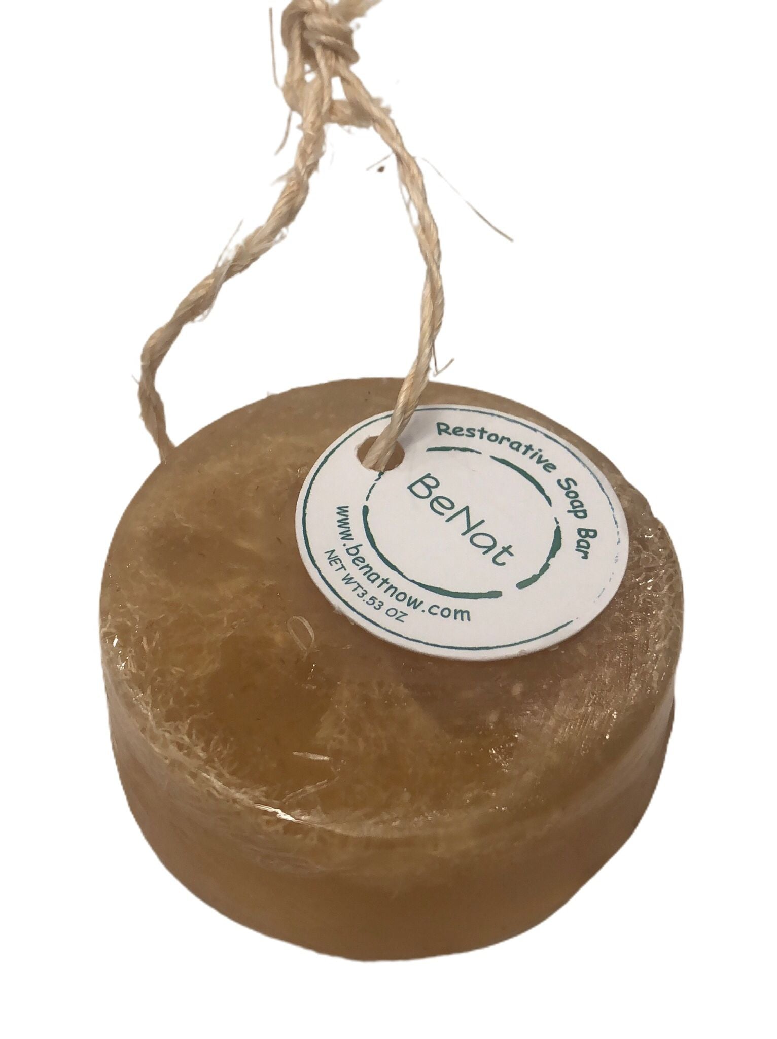 Restorative Soap Bar featuring oat, honey, and olive oil with a natural loofah for exfoliation, displayed elegantly.