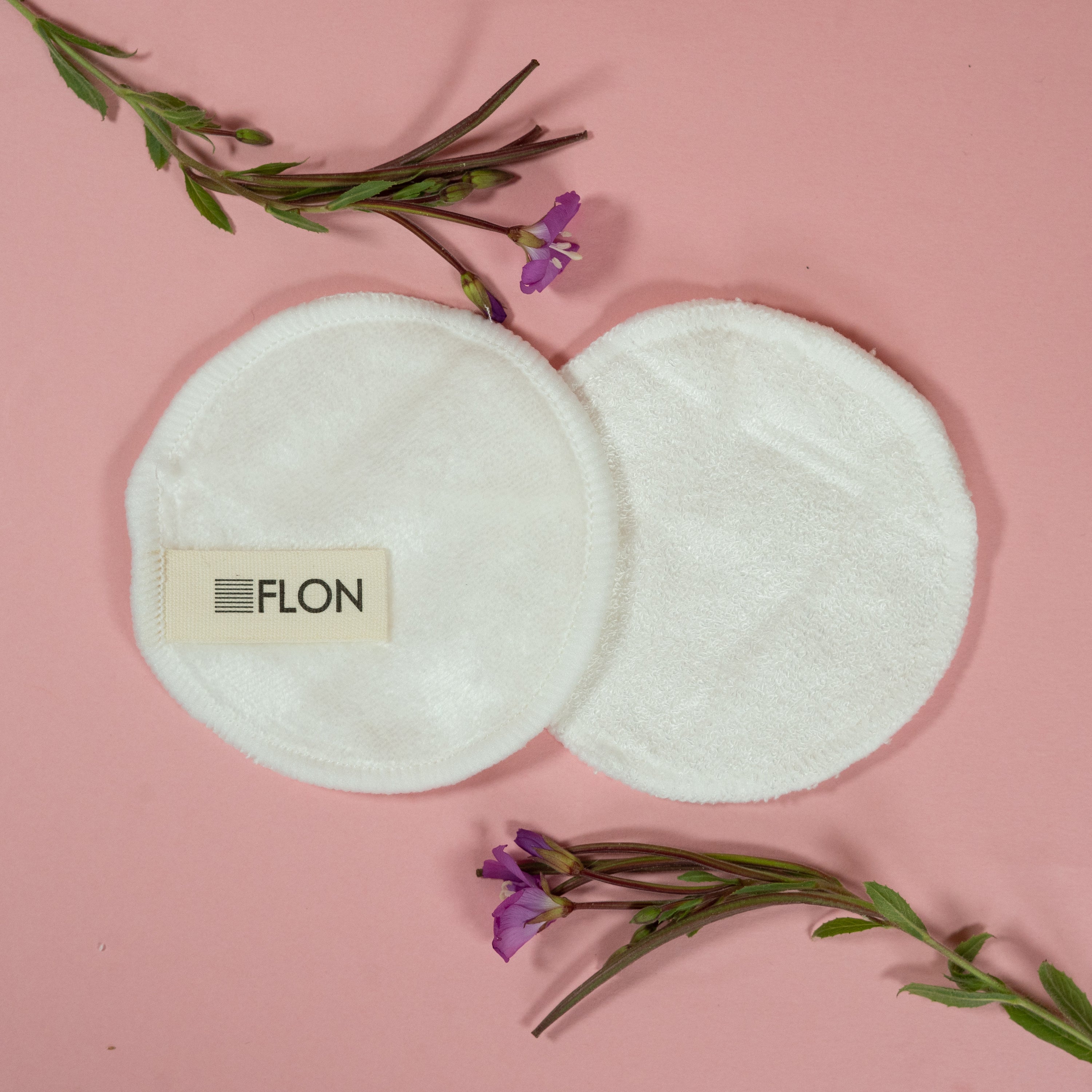 Set of 12 reusable bamboo makeup remover pads with a mesh laundry bag, showcasing soft velvet and textured terry cloth options.