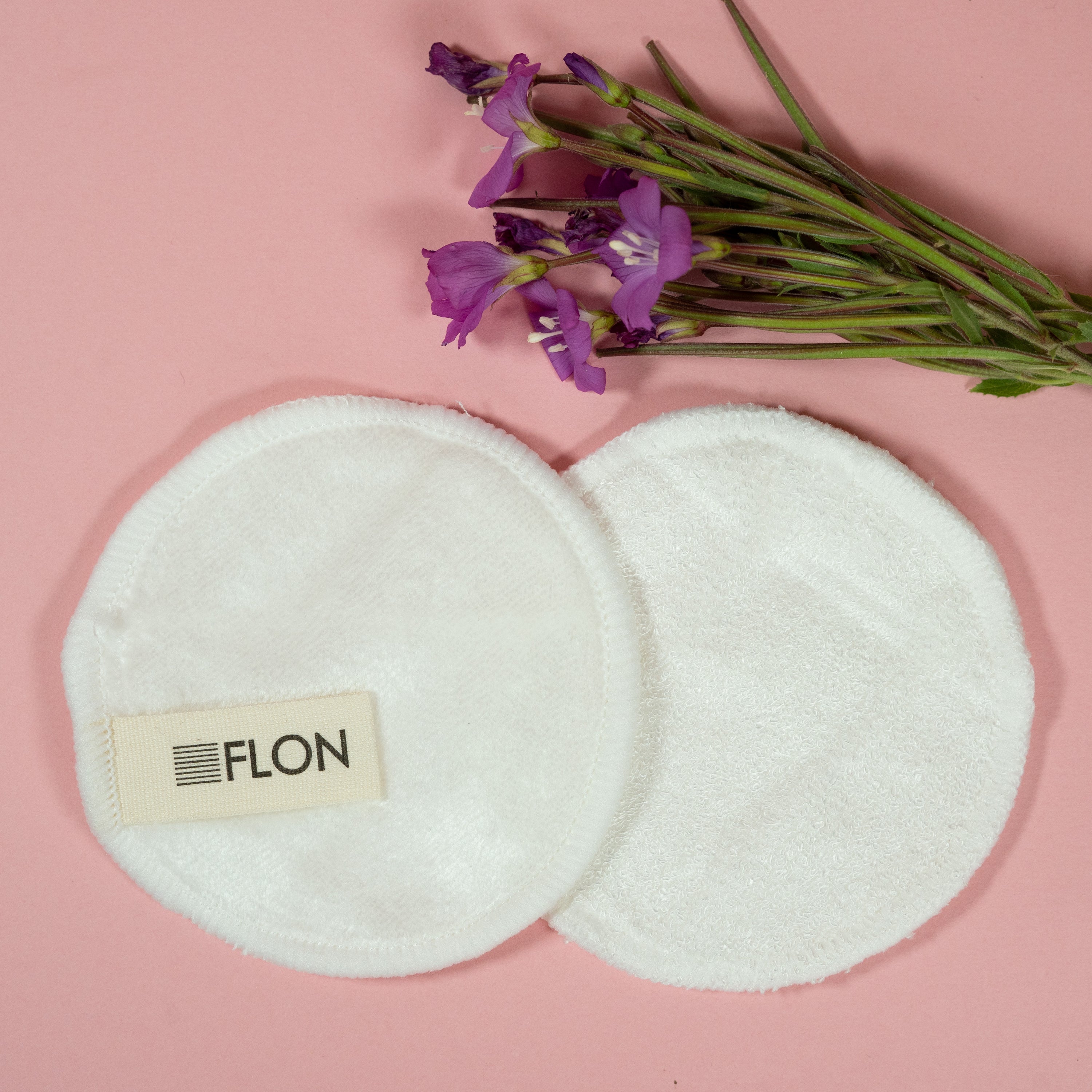 Set of 12 reusable bamboo makeup remover pads with a mesh laundry bag, showcasing soft velvet and textured terry cloth options.