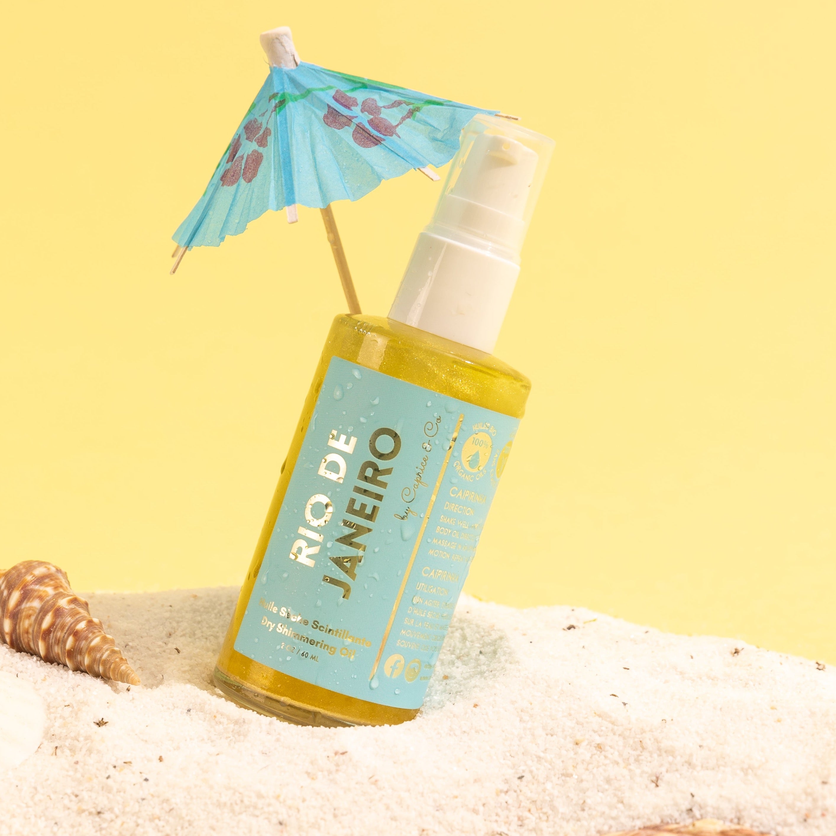 Bottle of Rio De Janeiro Dry Shimmering Oil with a shimmering golden hue, showcasing its tropical scent and organic ingredients.