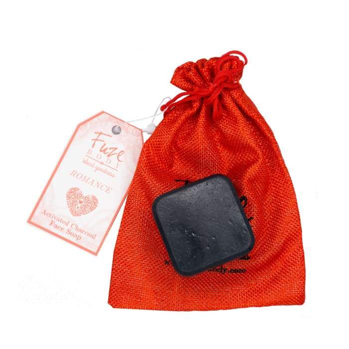 Romance Activated Charcoal Facial Soap with goat milk and jasmine essential oil, showcasing its luxurious texture and packaging.