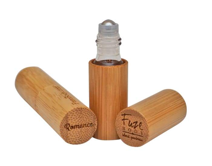 A roll-on bottle of Romance Wood Pure Essential Oils featuring Jasmine and pheromones, designed for sensuality and skin safety.