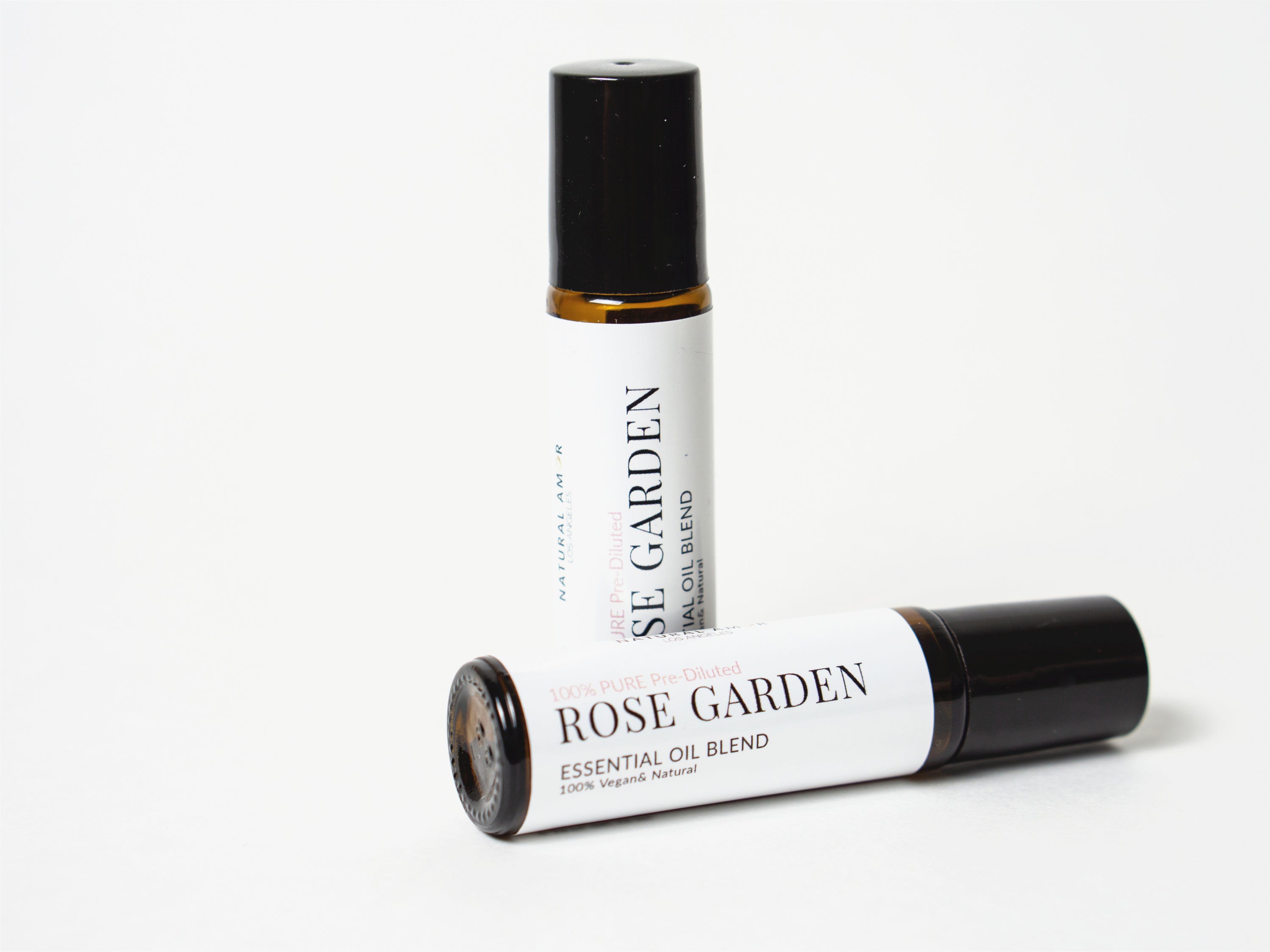 Rose Garden Roll On Essential Oil Blend in a 10 mL bottle with a stainless steel rollerball, showcasing its floral and earthy essence.