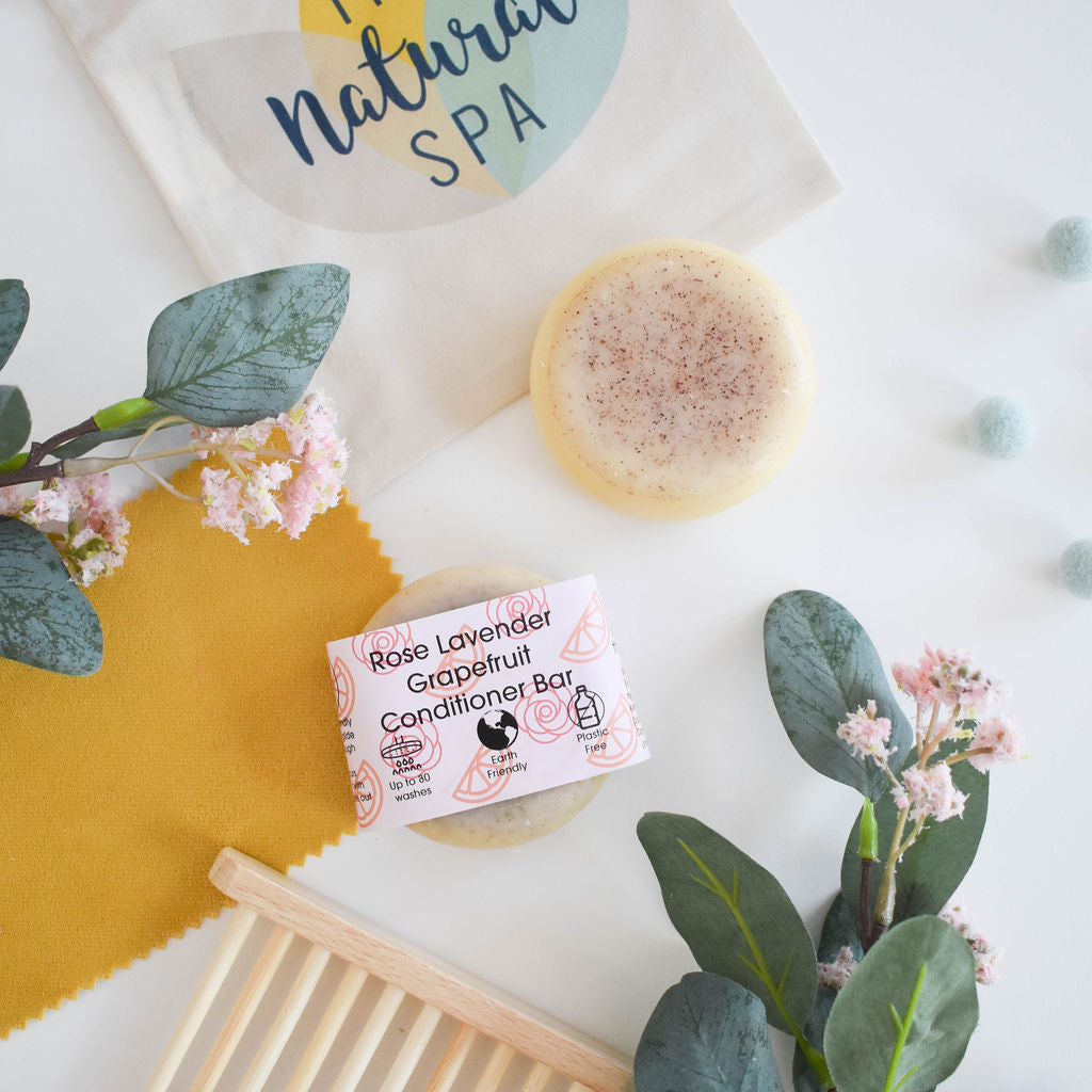 A beautifully crafted solid conditioner bar featuring rose, grapefruit, and lavender scents, showcasing its unique design and eco-friendly packaging.