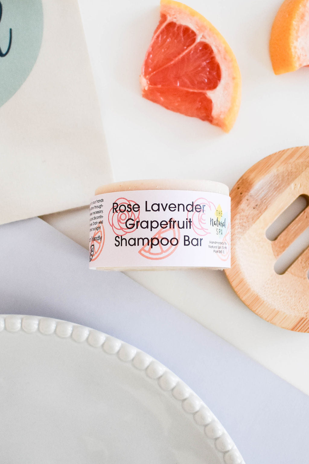 A vibrant shampoo bar featuring rose, lavender, and grapefruit scents, showcasing its unique design and eco-friendly packaging.