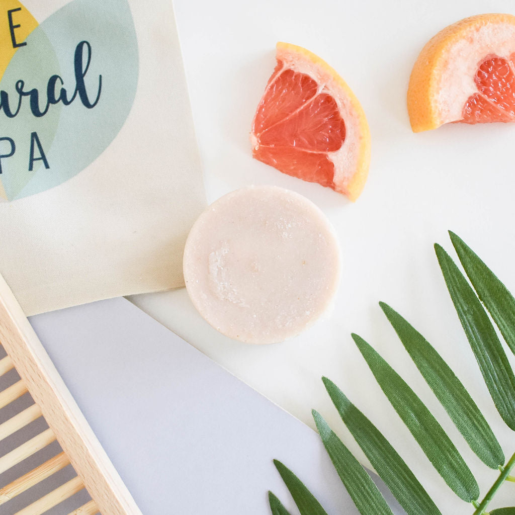 A vibrant shampoo bar featuring rose, lavender, and grapefruit scents, showcasing its unique design and eco-friendly packaging.